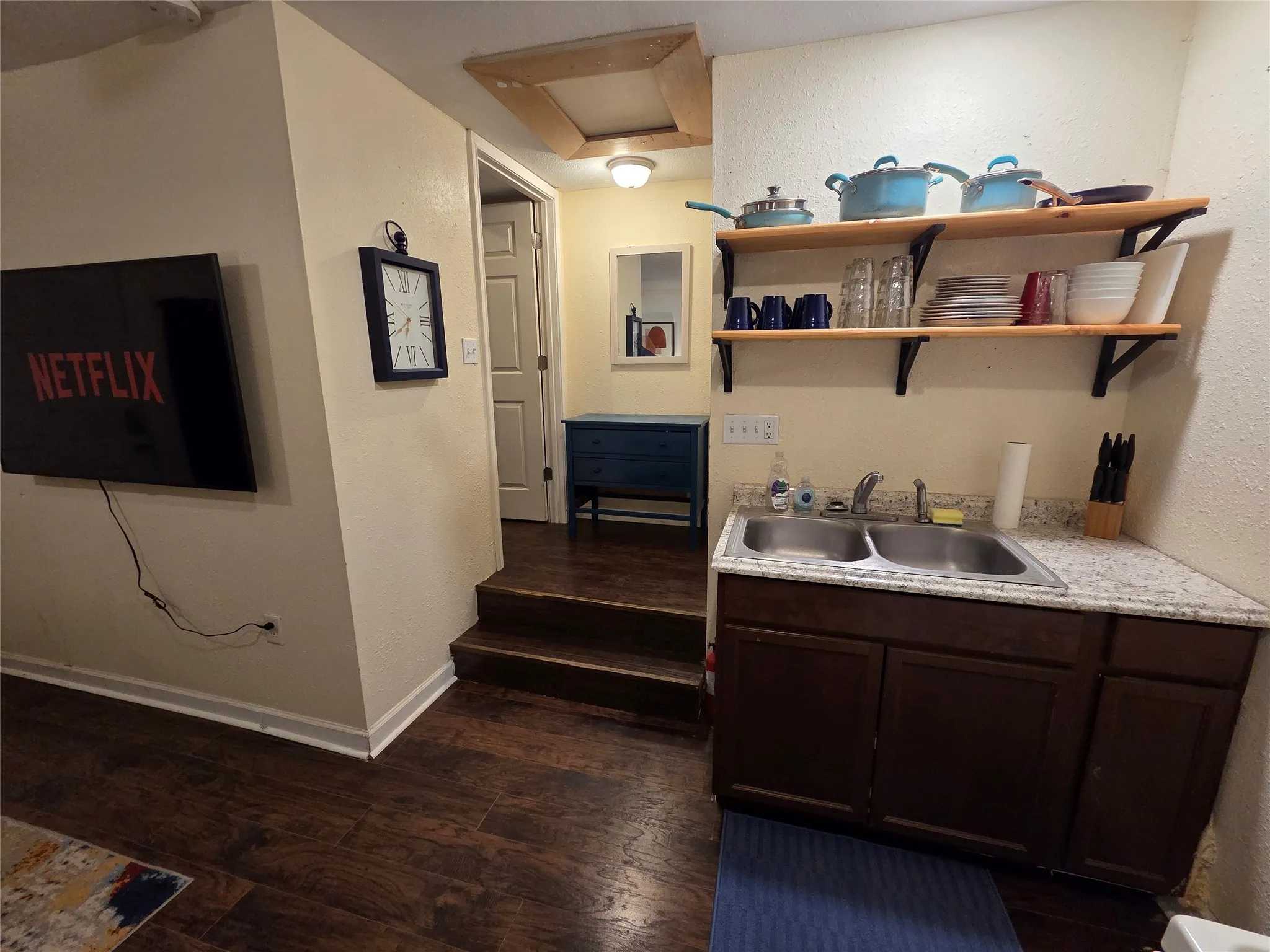 There are steps leading up to the hallway that takes you to the bathroom and bedroom.