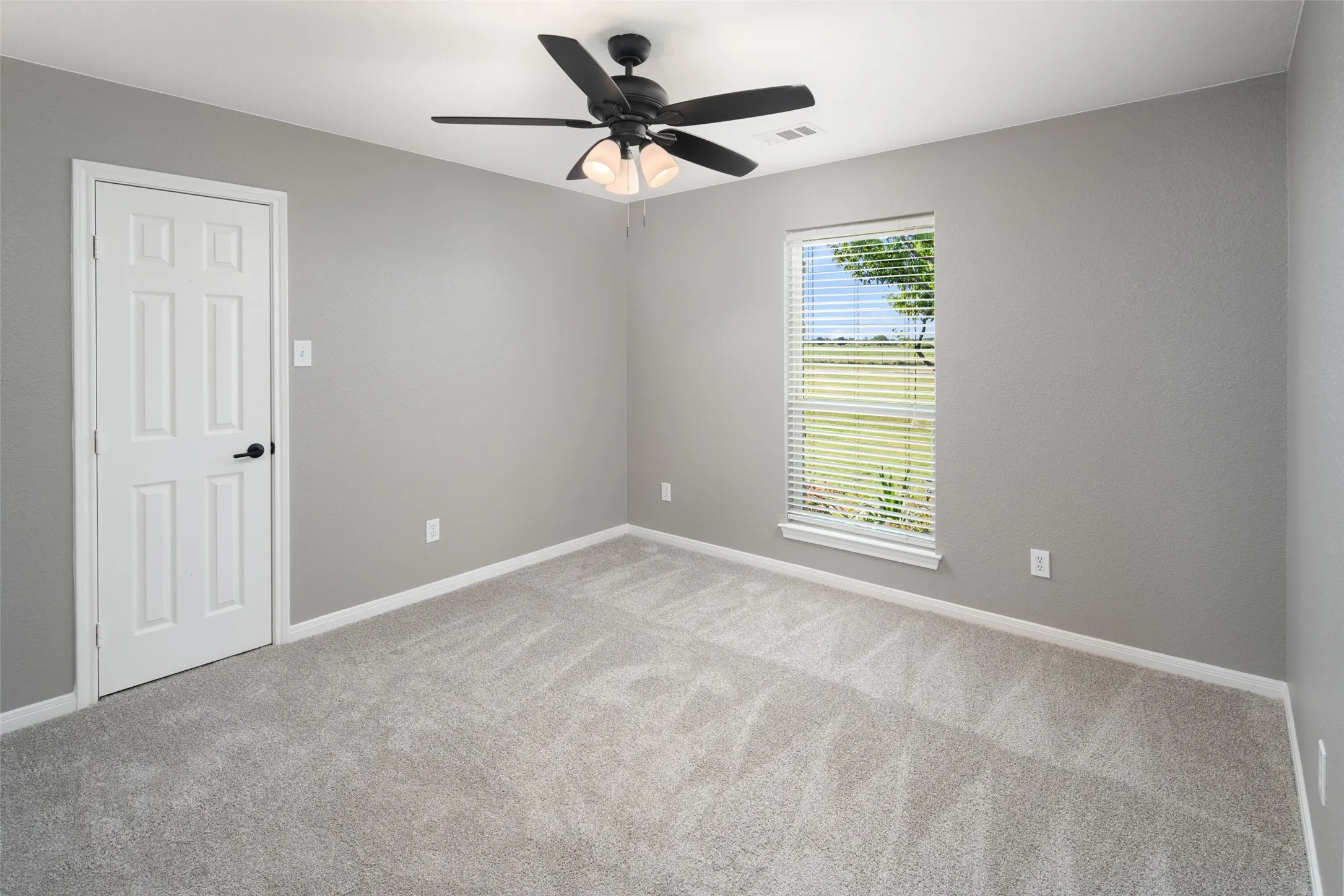 Neutral gray walls complement light-toned carpeting