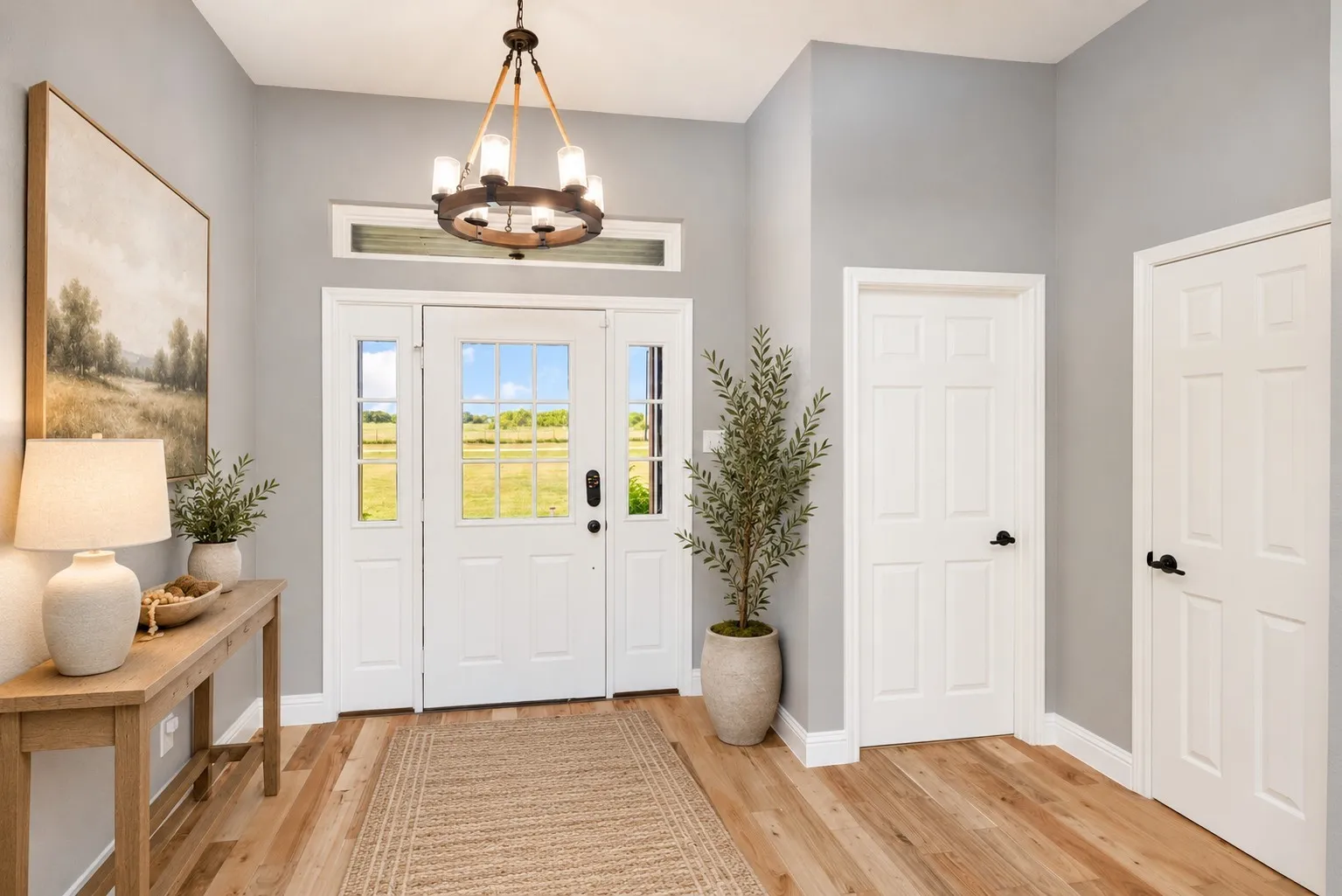 Entryway featuring a decorative chandelier and wood-finish flooring