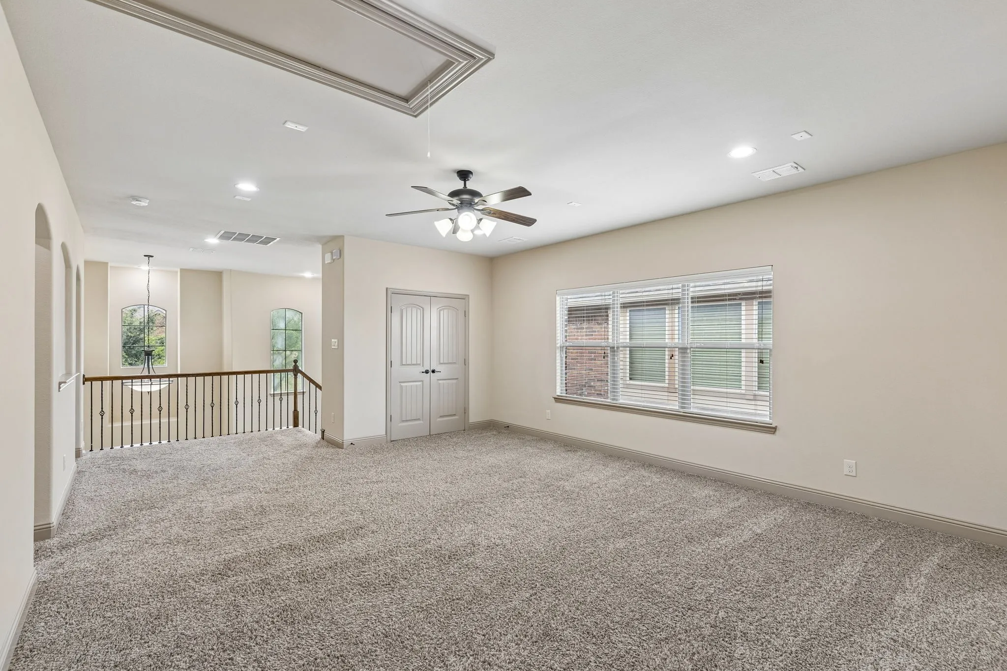 Spacious second floor game room featuring neutral carpeting, a multi-speed ceiling fan with integrated lighting, and recessed ceiling​​‌​​​​‌​​‌‌​‌‌​​​‌‌​‌​‌​‌​​​‌​​ lights