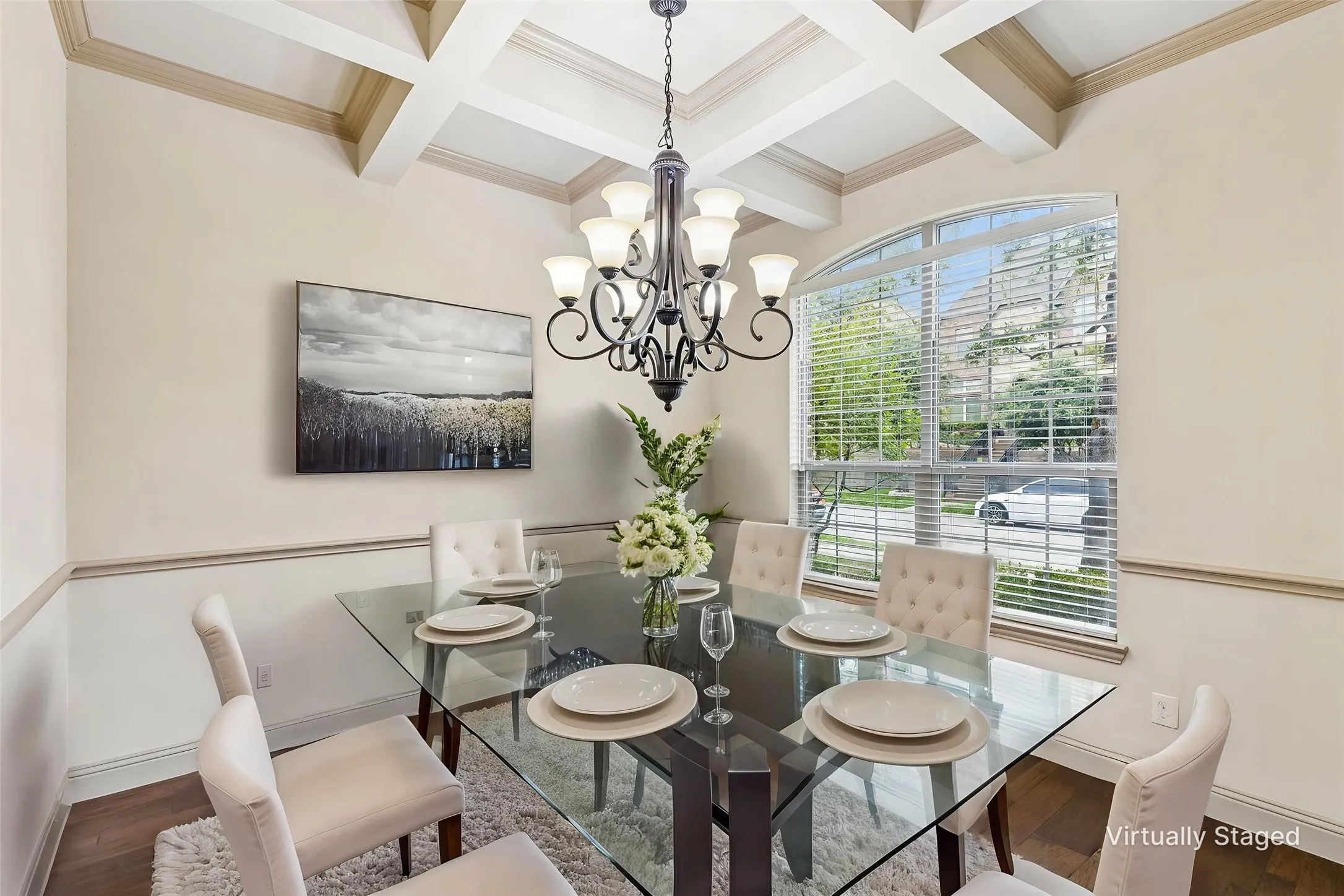 Dining area featuring a coffered ceiling, elegant chandelier, and wood-finish flooring