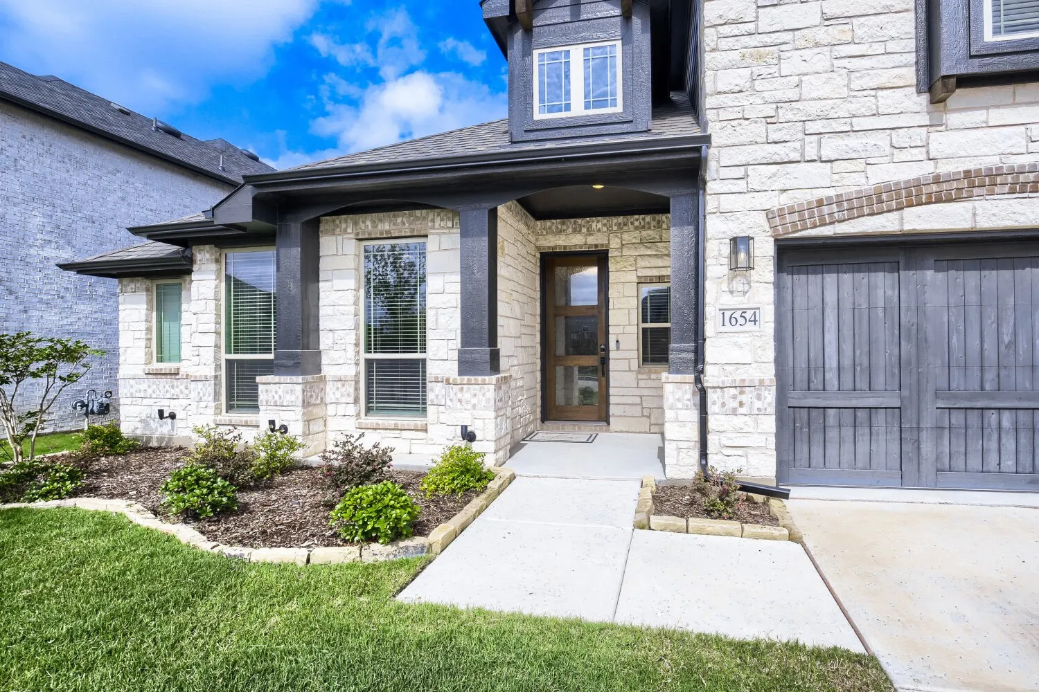 Stone veneer exterior with dark trim accents