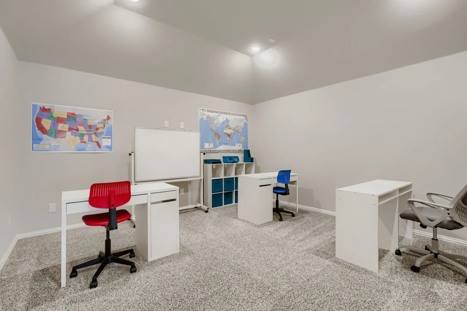 Spacious room with light-toned wall paint and textured carpeting