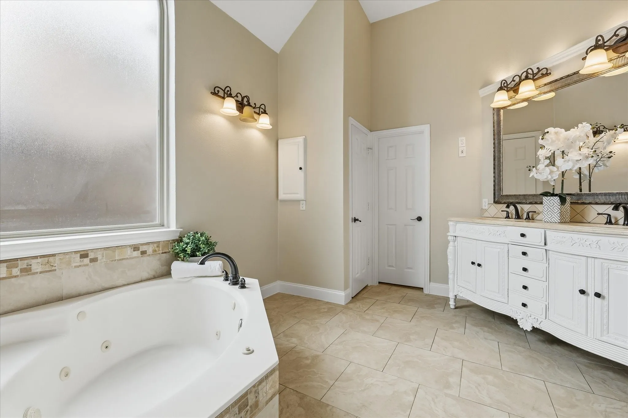 Primary bath has separate tub, large walk-in shower and double vanities.