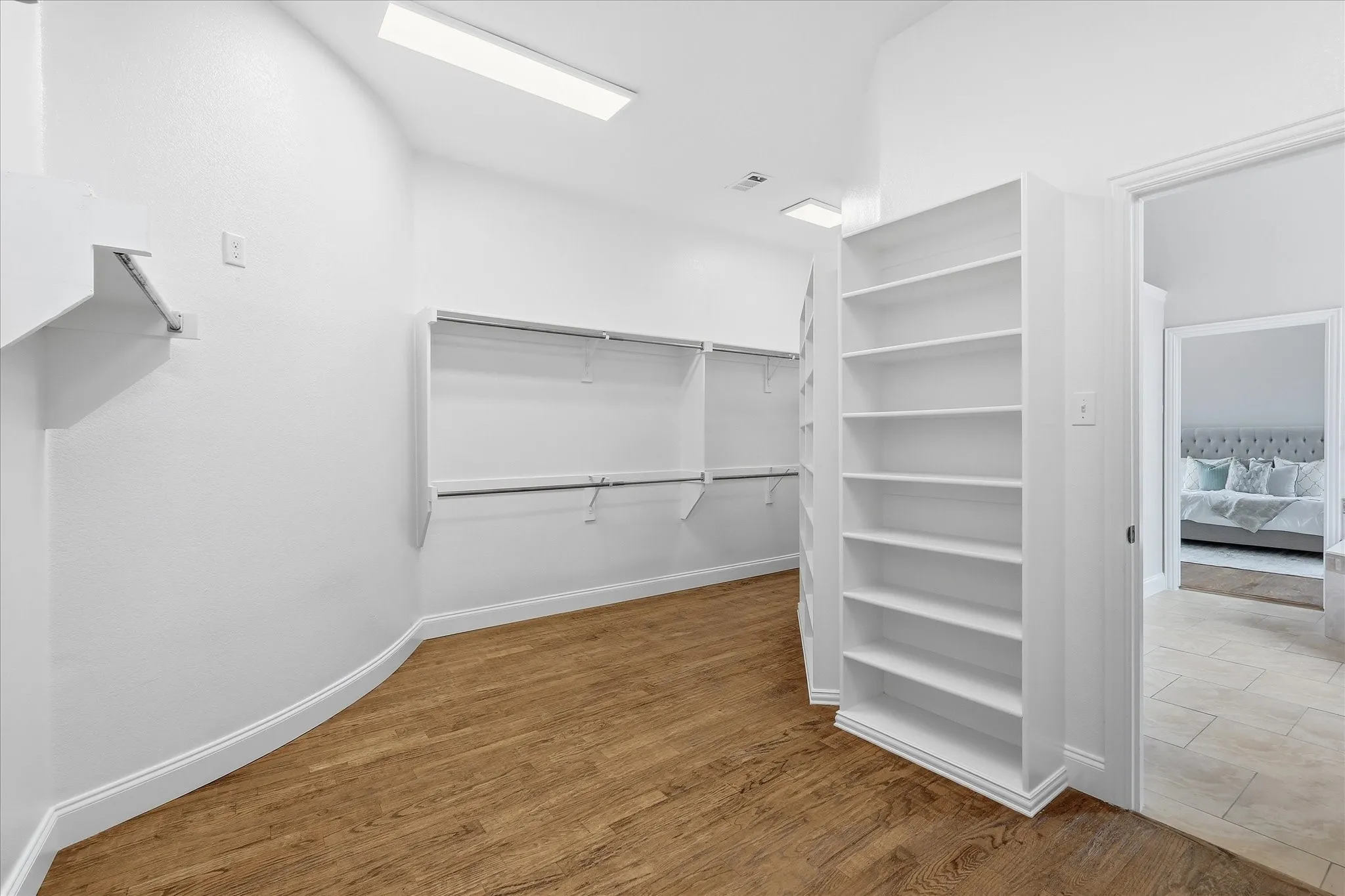 Large primary closet has lots of shelves.