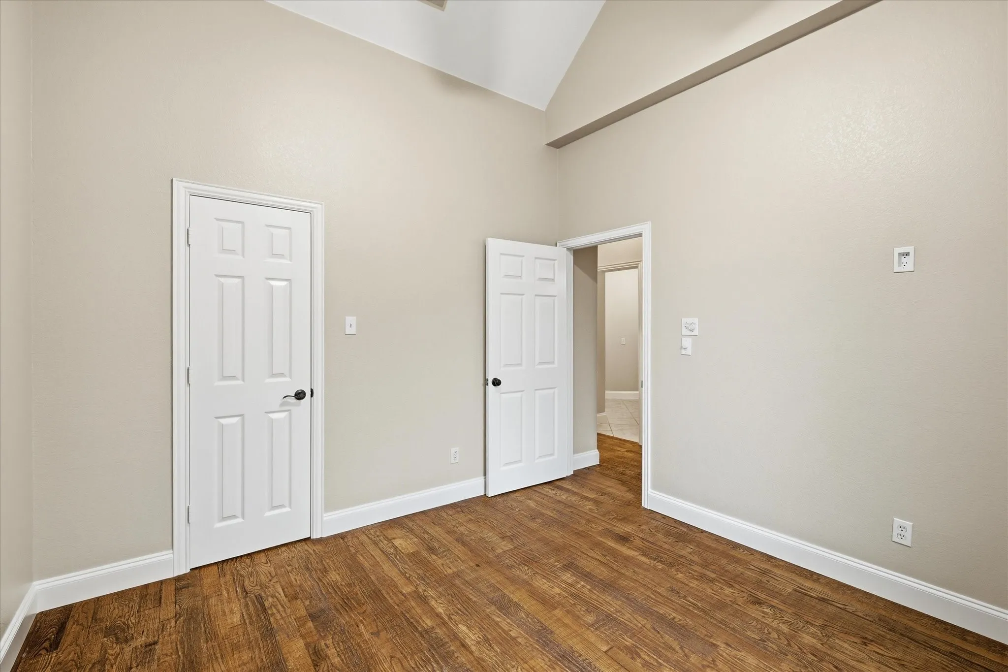 Secondary downstairs bedroom. Full bathroom to the right as you walk out.