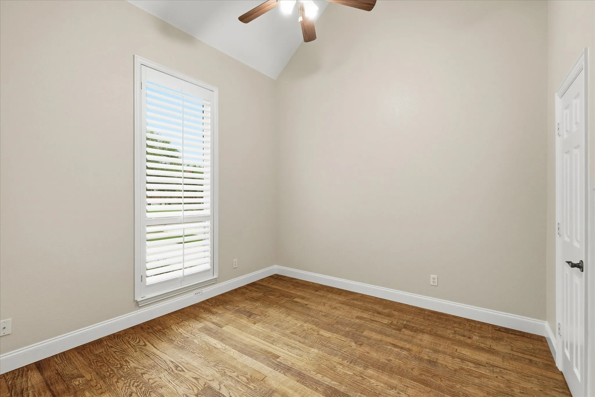 Secondary downstairs bedroom with fan and large closet.