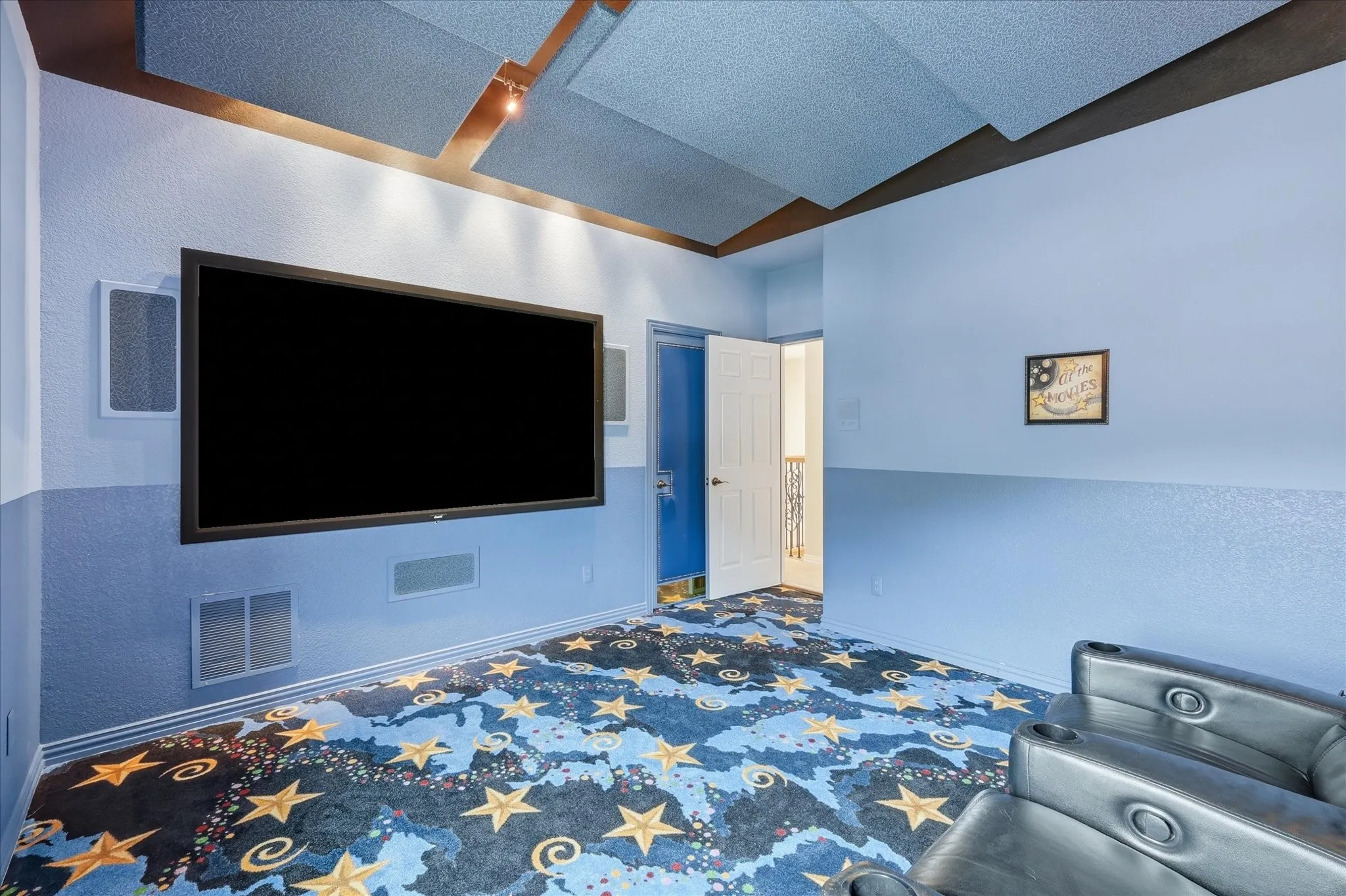 Media room has high end speakers and acoustic panels on the ceiling for the full theater experience.