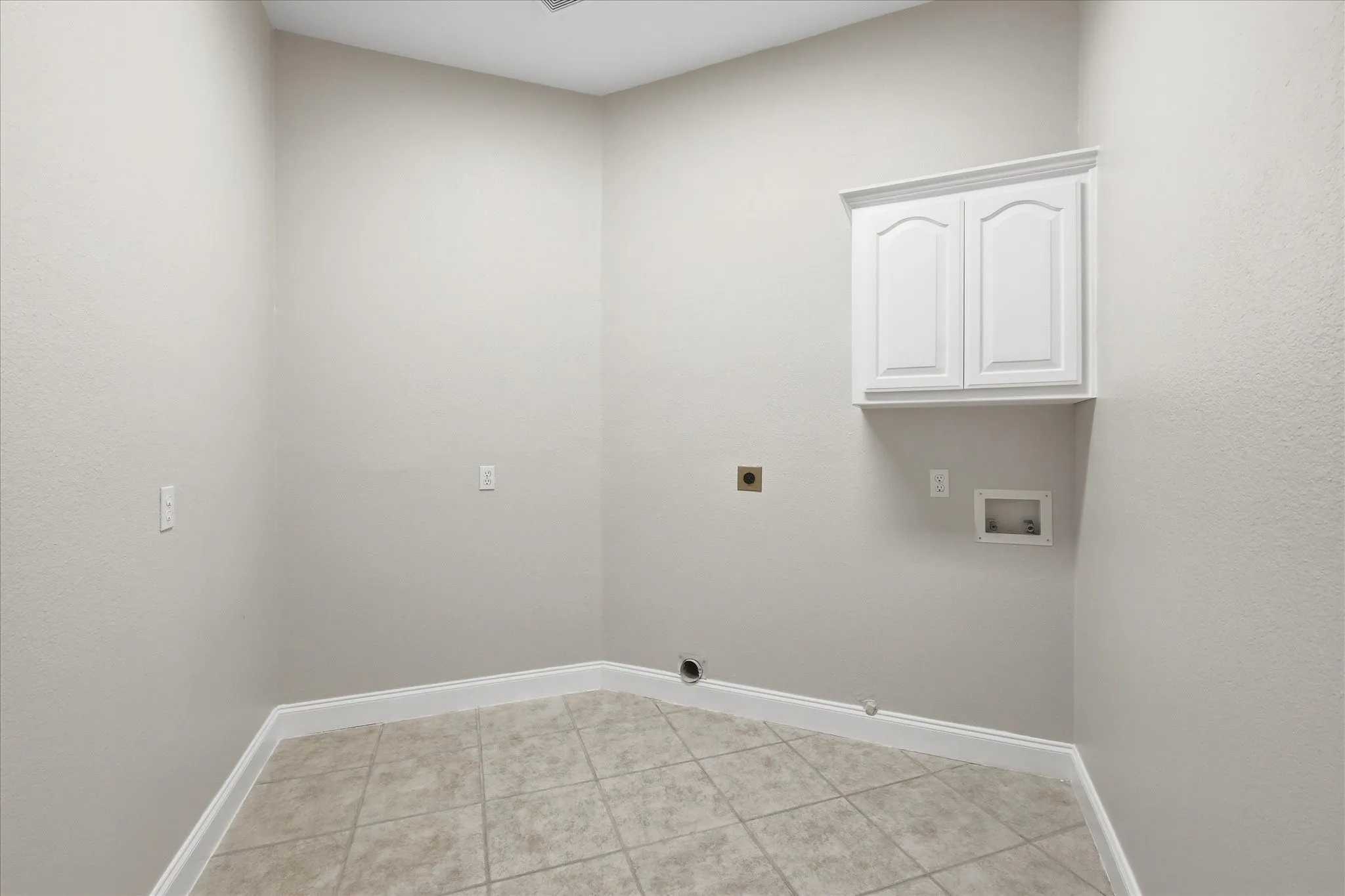 Laundry room has built-in cabinet and plenty of room for an extra refrigerator and maybe also a freezer. Directly across from large walk-in pantry.
