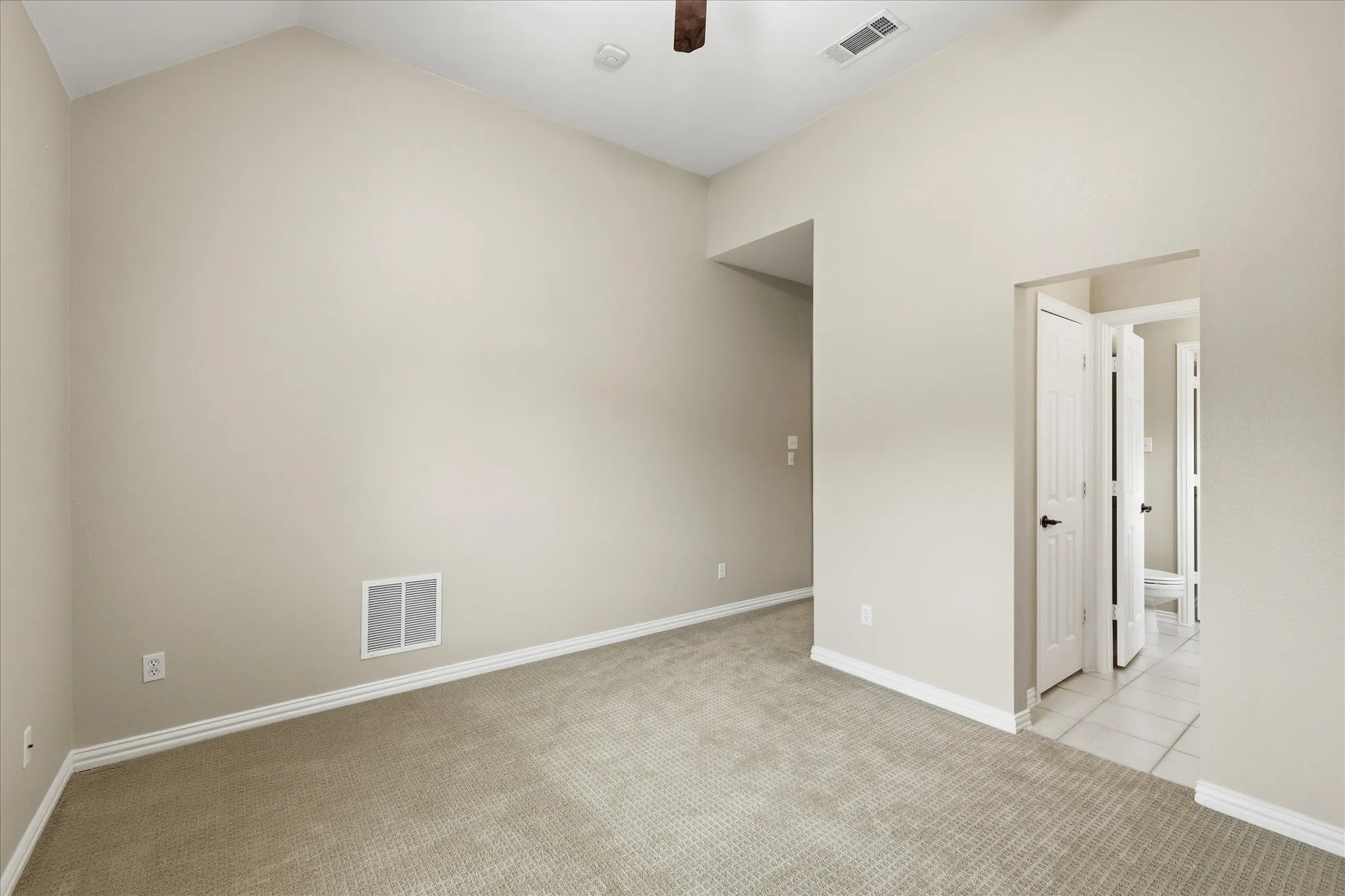 Upstairs bedroom has high ceiling and Jack & Jill bath