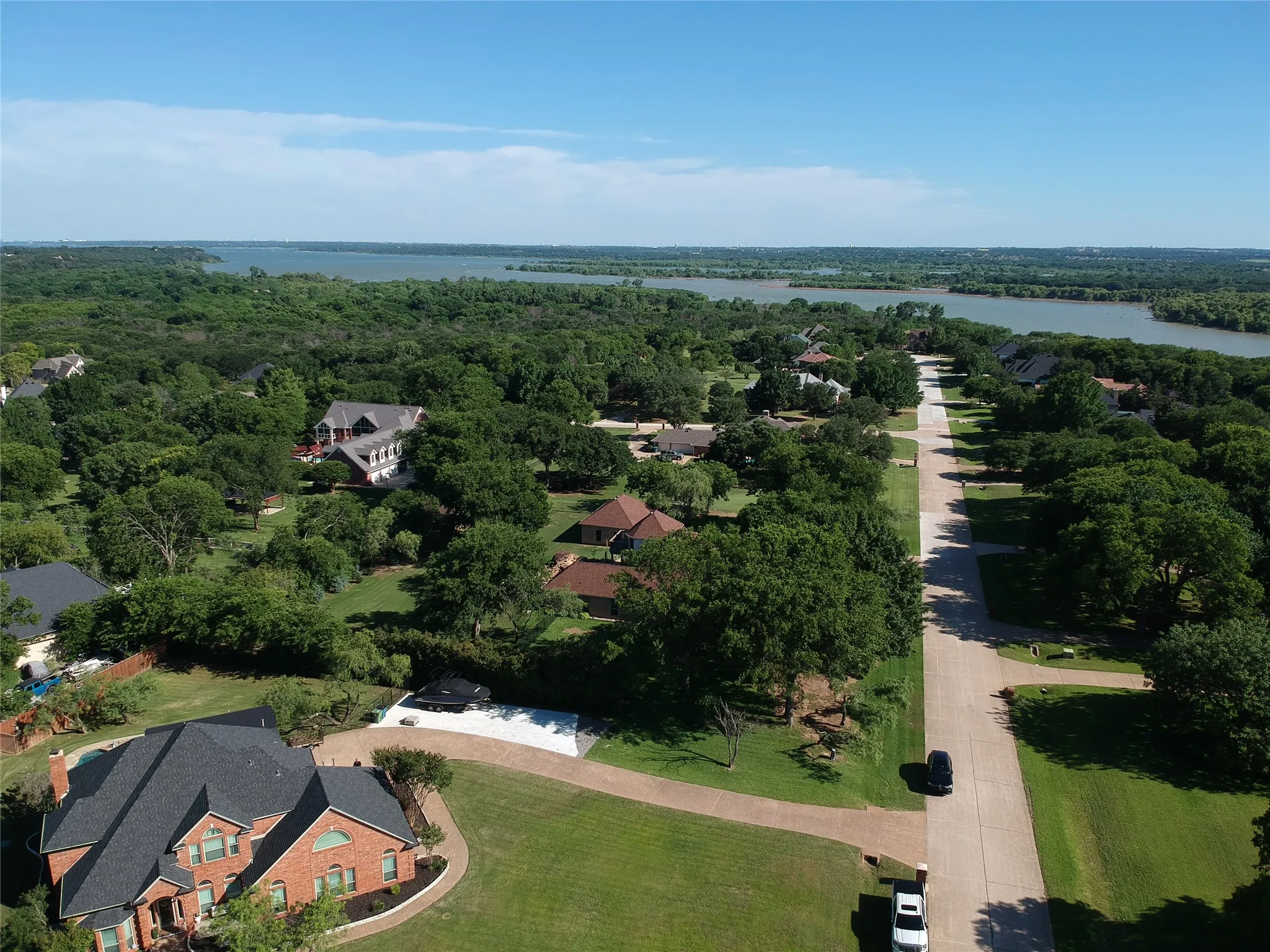 Expansive property featuring a brick exterior and a dark shingle roof