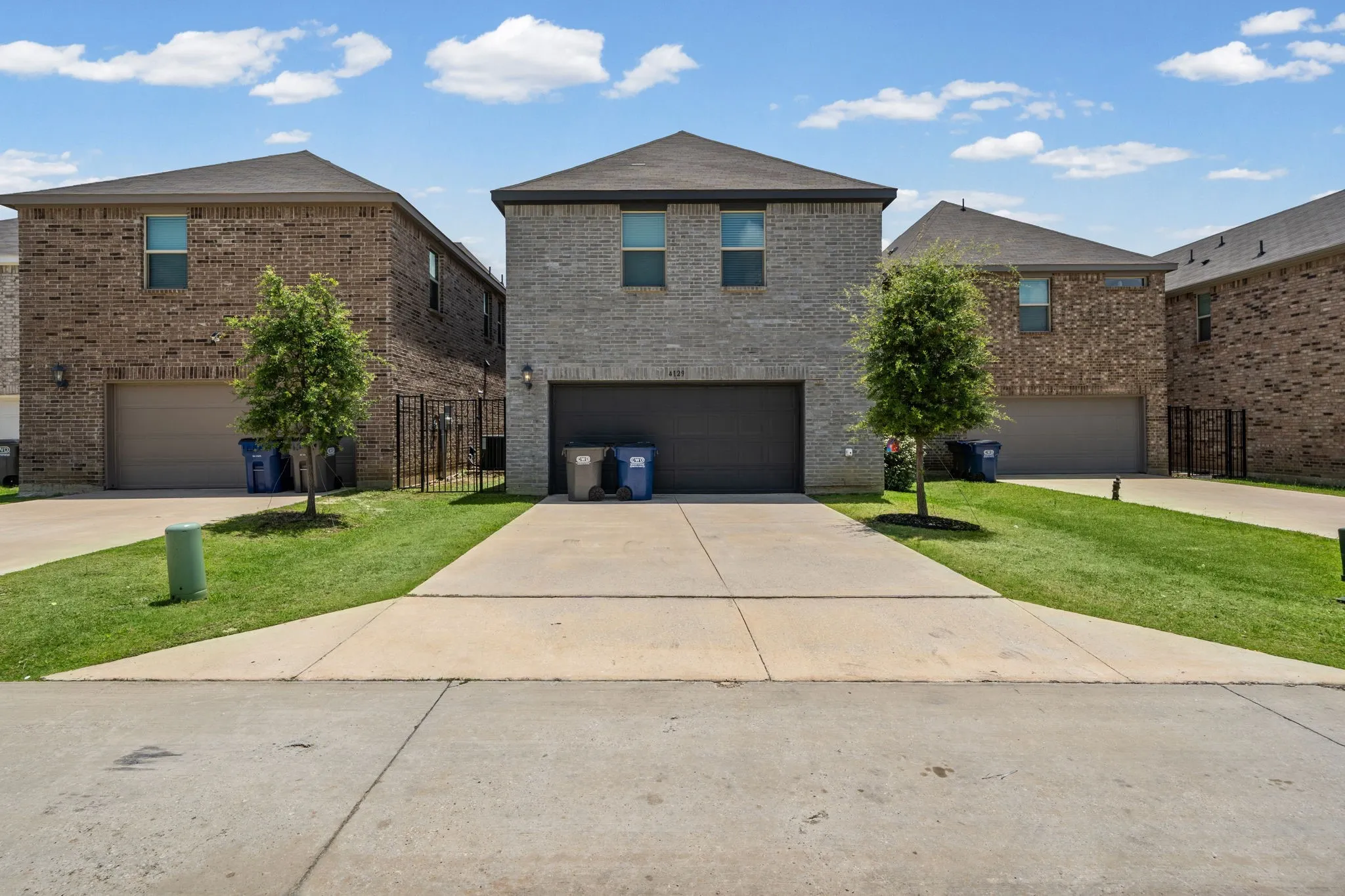 Brick exterior with a dark roof and a two-car garage
