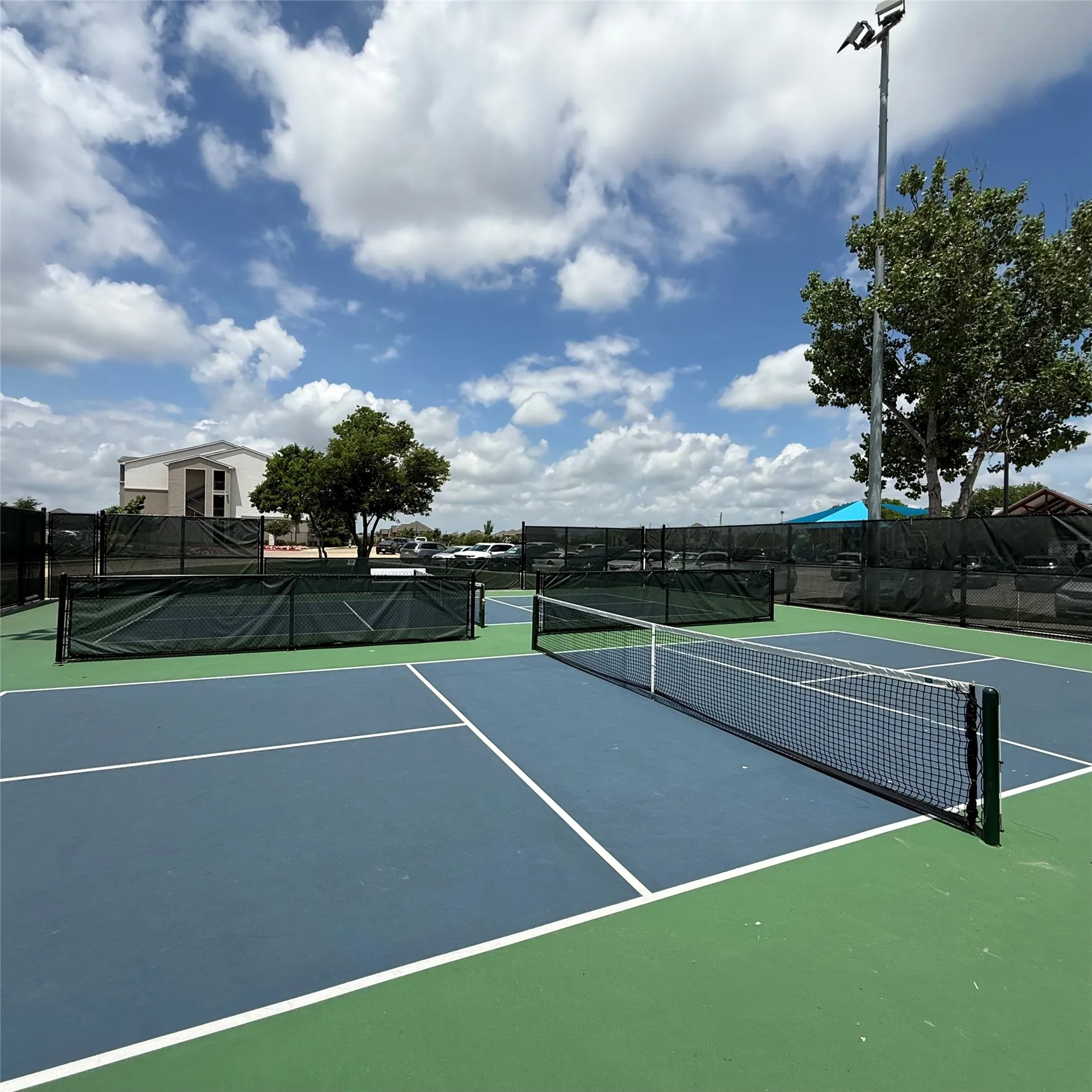 Outdoor recreation area featuring multiple courts with blue and green surfacing