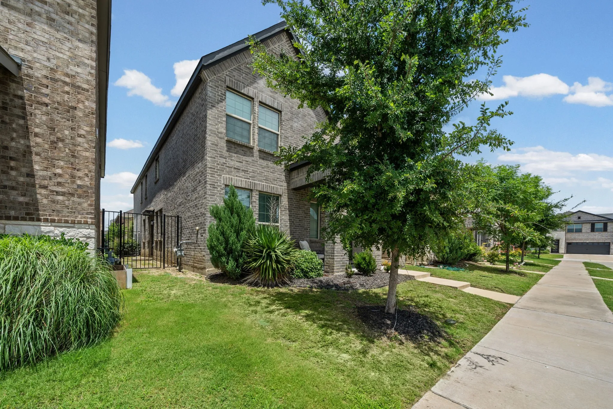 Two-story brick exterior with a black roof
