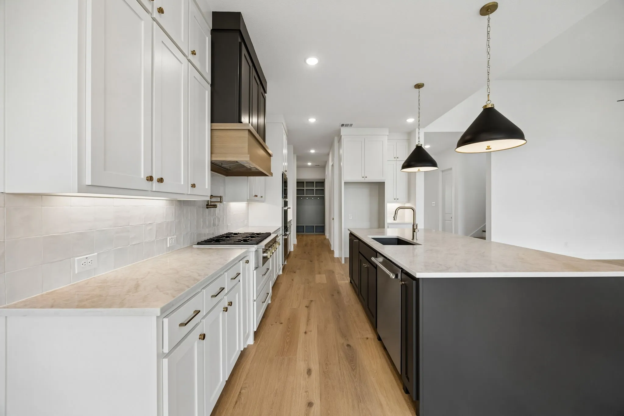 With beautiful double stacked-two toned cabinetry, gorgeous counter tops and designer selected backsplash effortlessly pair with contemporary stainless steel to create a kitchen for the ages!