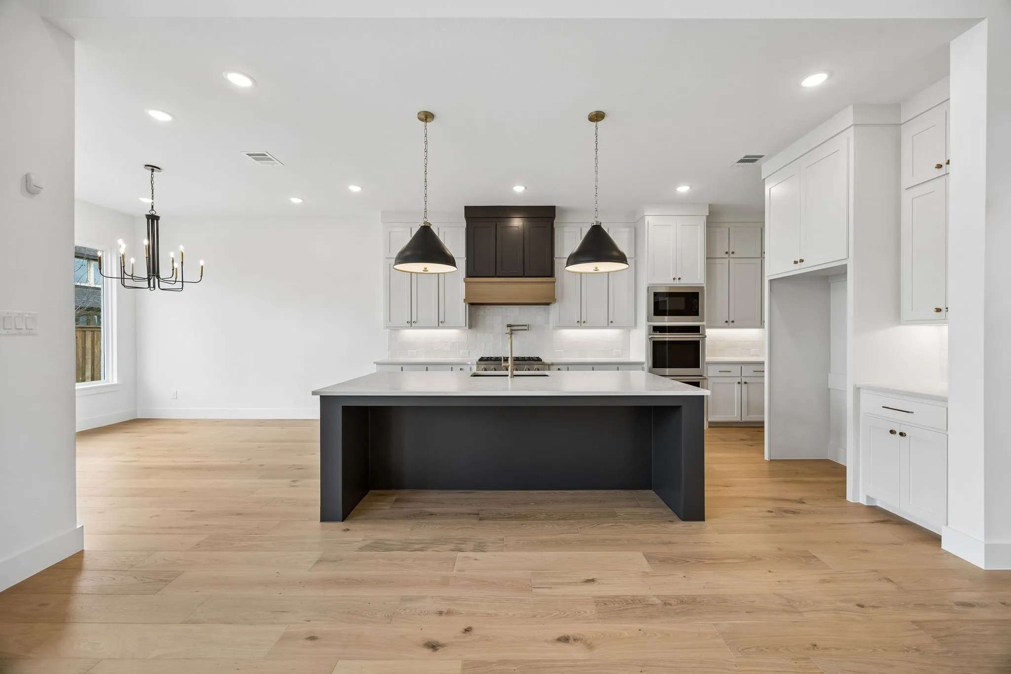 The spacious kitchen island is the perfect place for friends and family to gather round.
