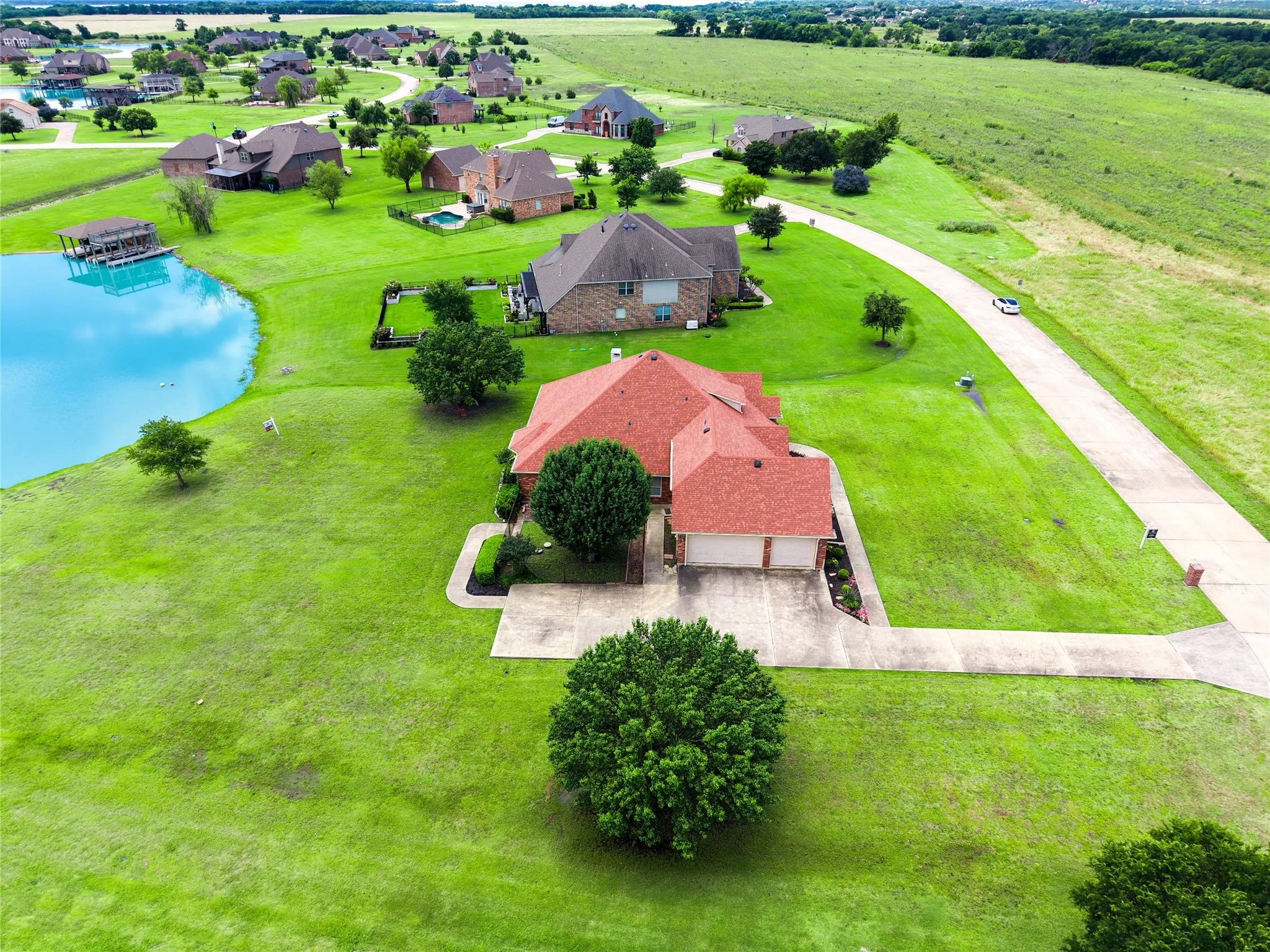 Spacious property featuring a red tile roof, an attached two-car garage, and a concrete driveway