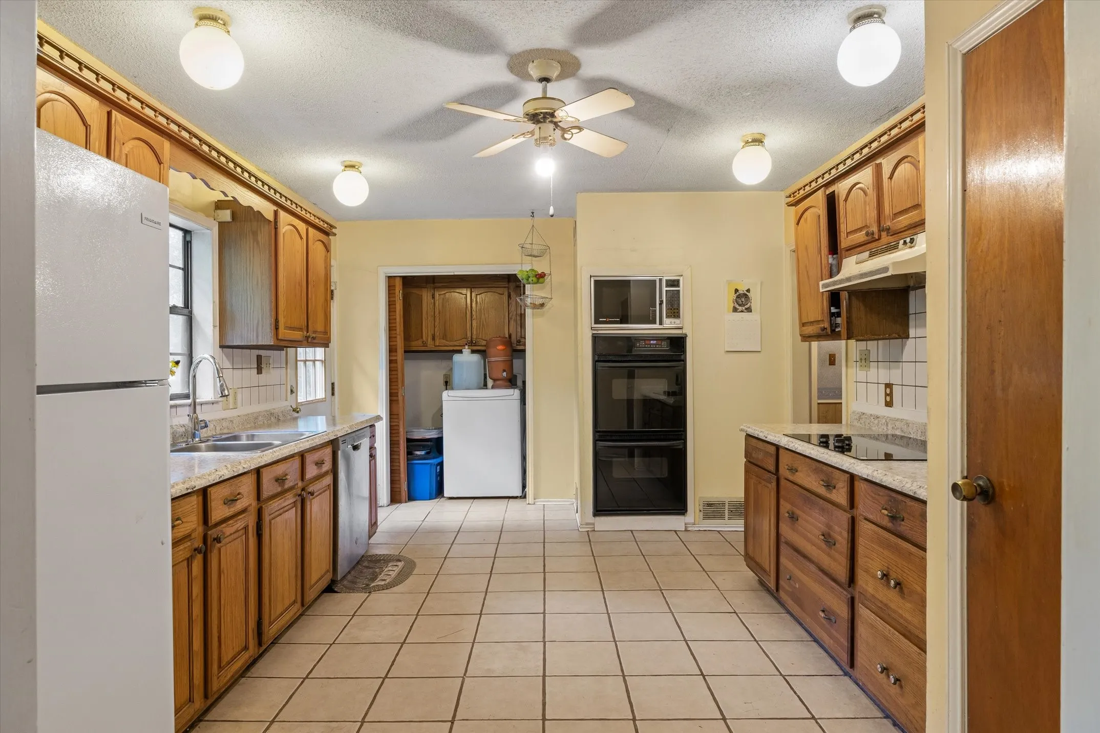 Kitchen with pantry, double ovens and dishwasher.
