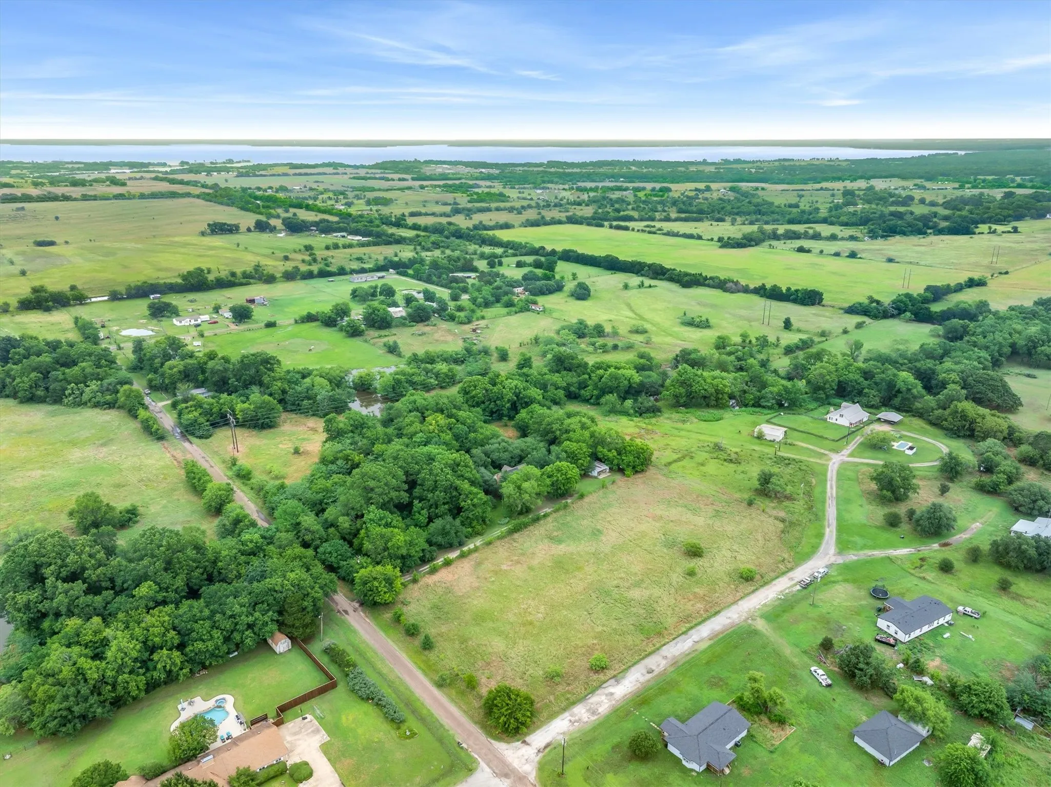 1343 feet of road frontage. Great for investors or adding to the property. Pasture in front, house in the middle and woods and pond in the back
