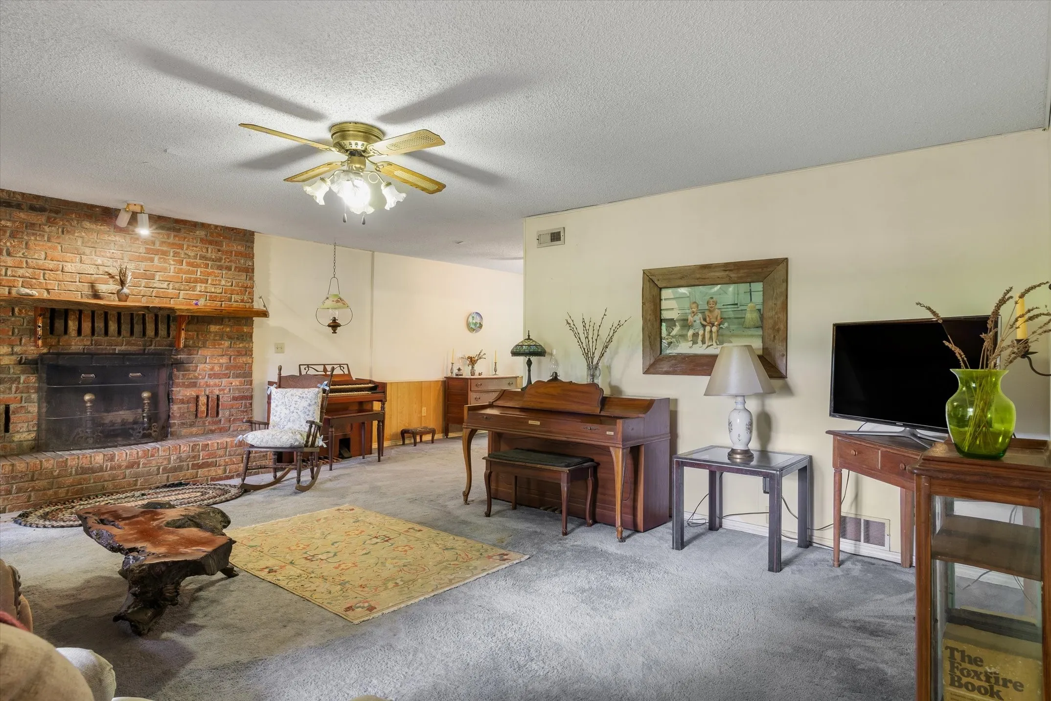 Large living room with wood burning fireplace.