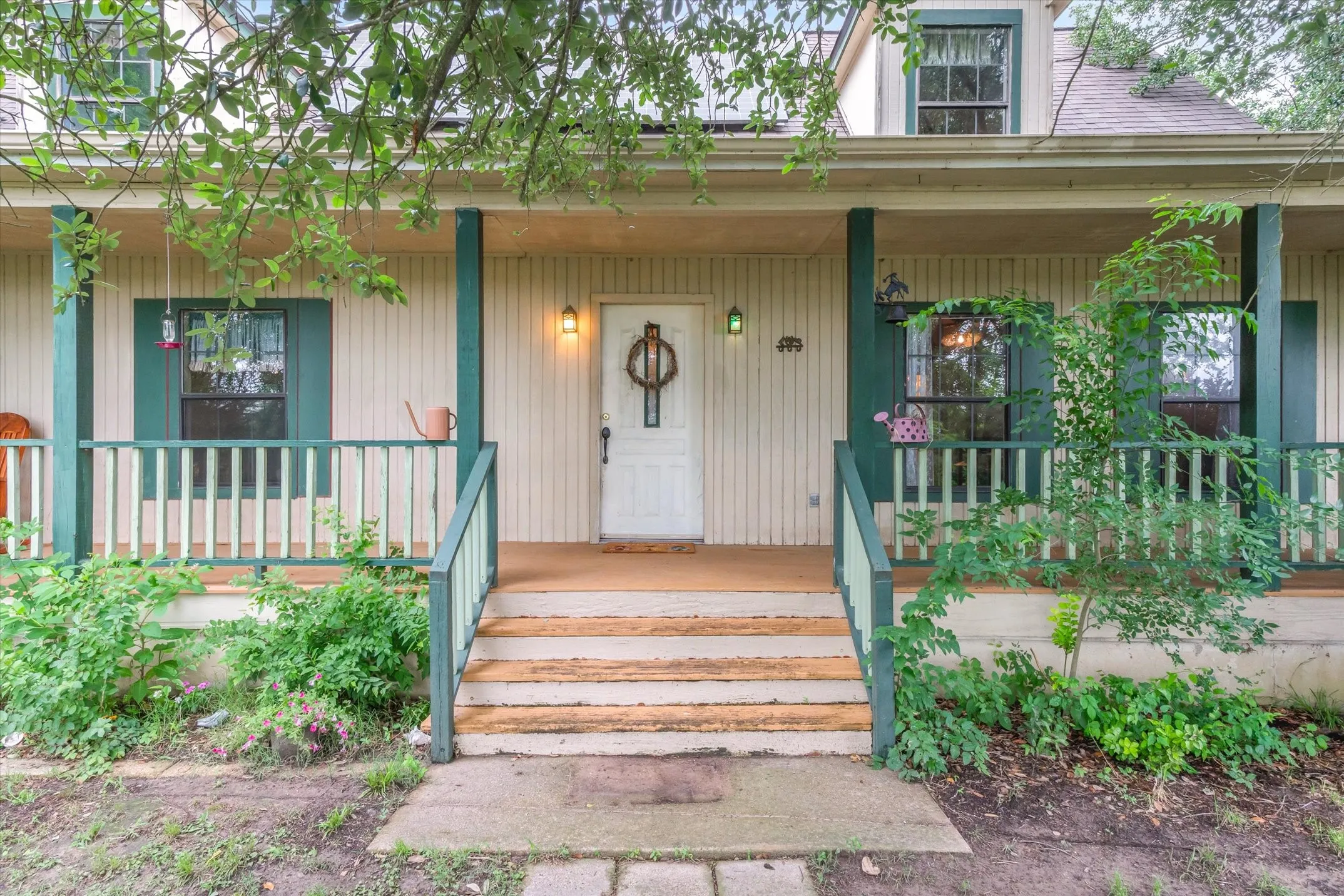 Front country porch invites you into this quaint farmhouse.