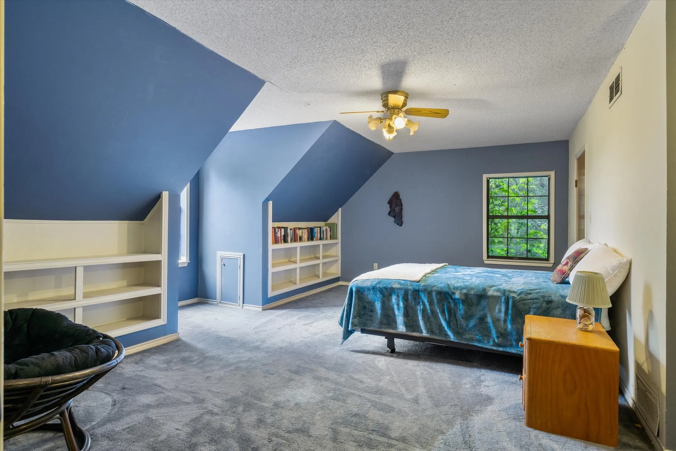 Ample sunlight in this room with built-in bookshelves and large closet.