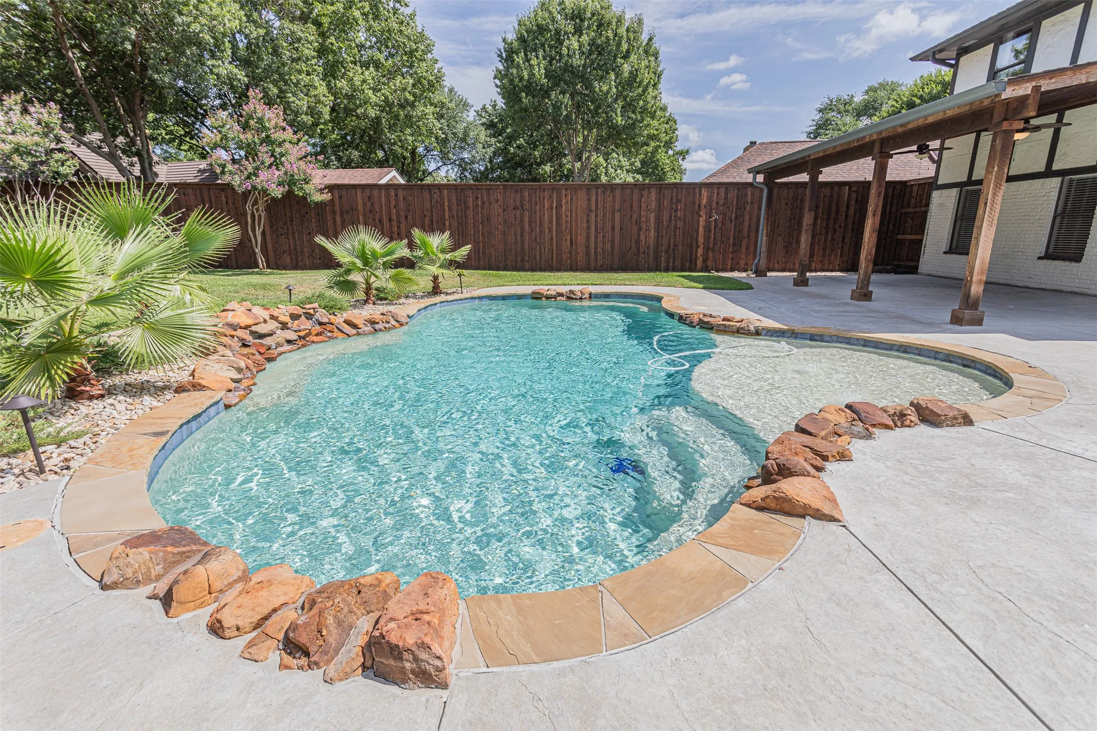 Sparkling pool with beautiful stone coping.