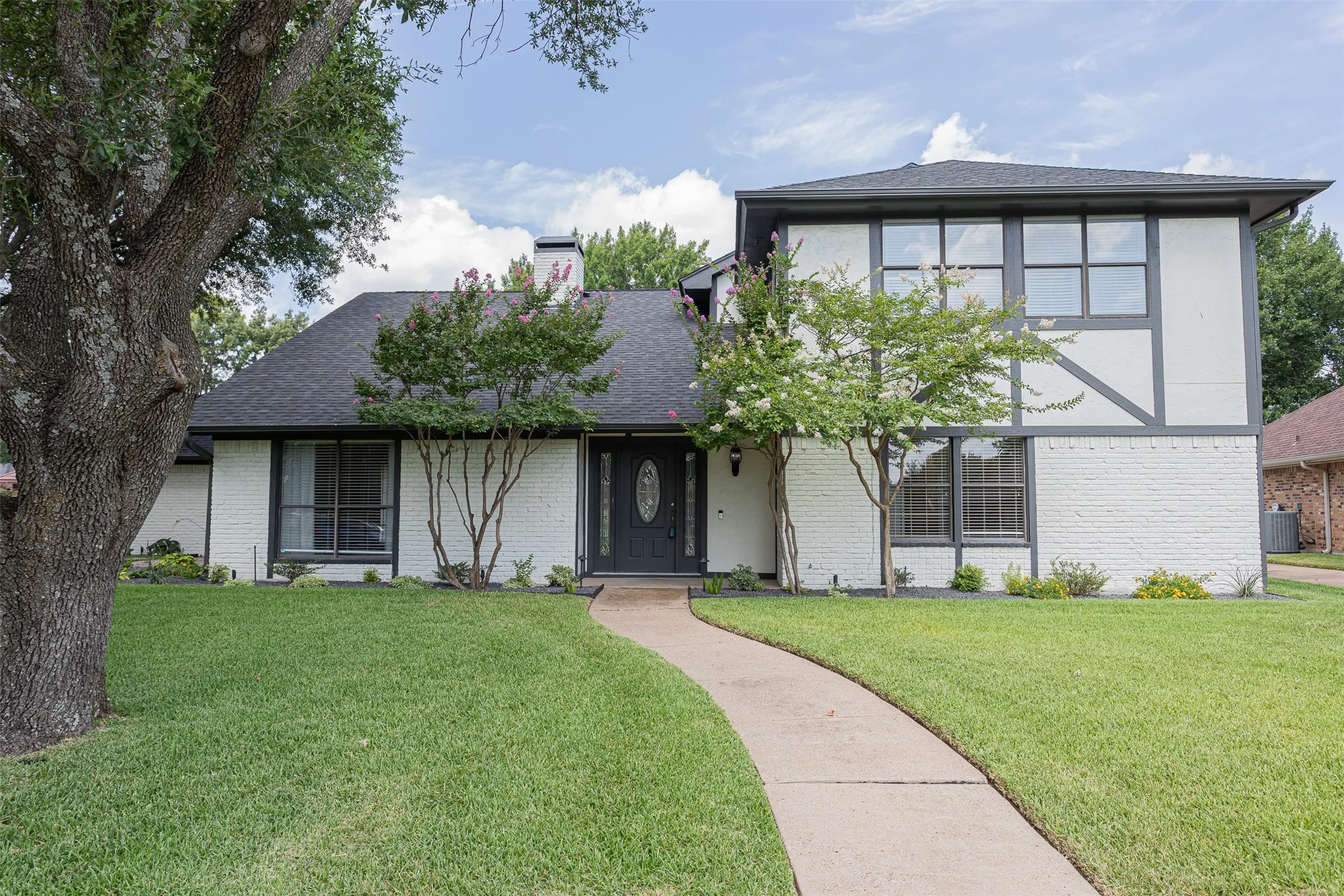 Welcoming front entry with beautifully landscaped walkway.