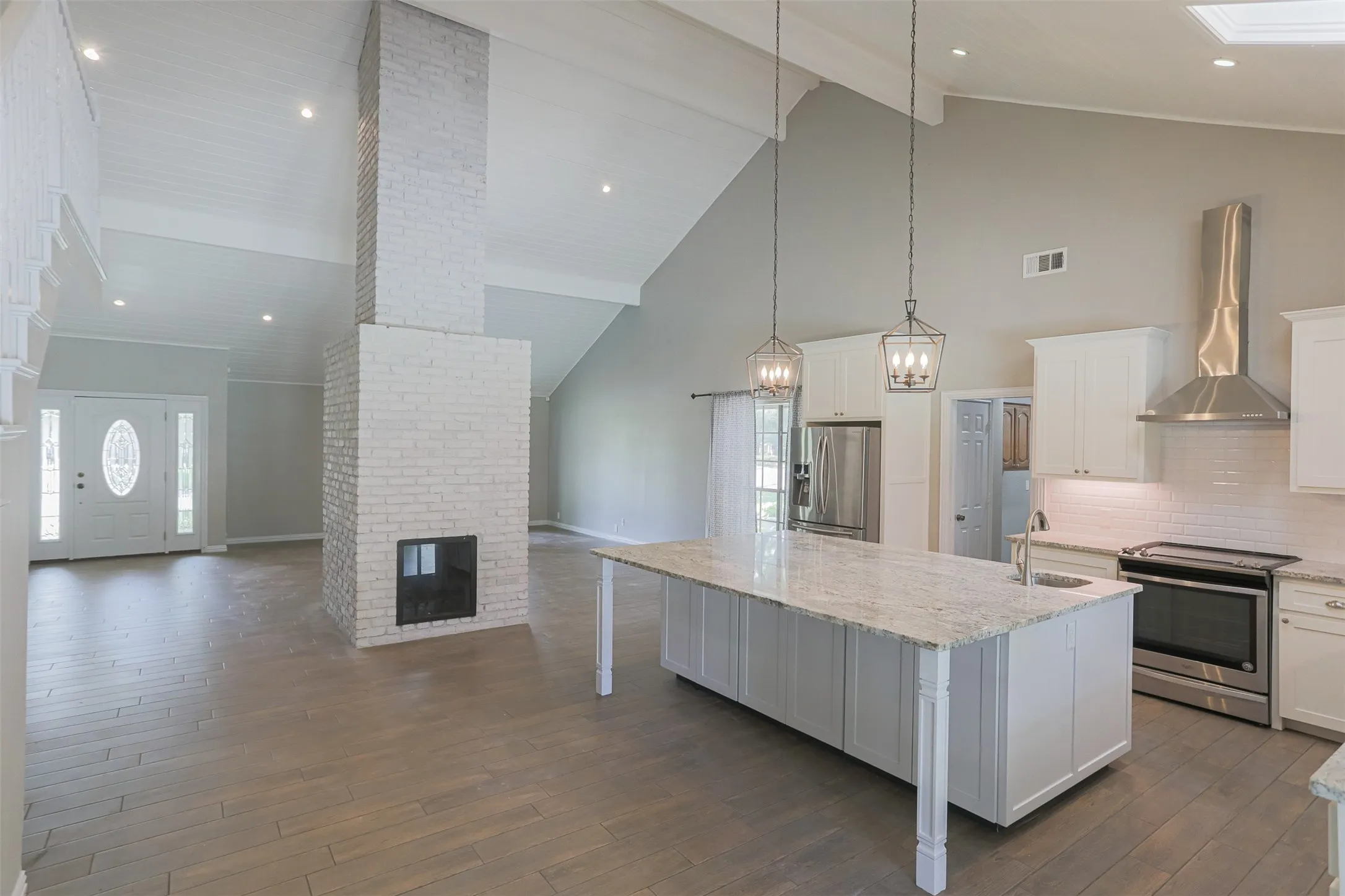 Updated kitchen featuring large center island and custom cabinetry