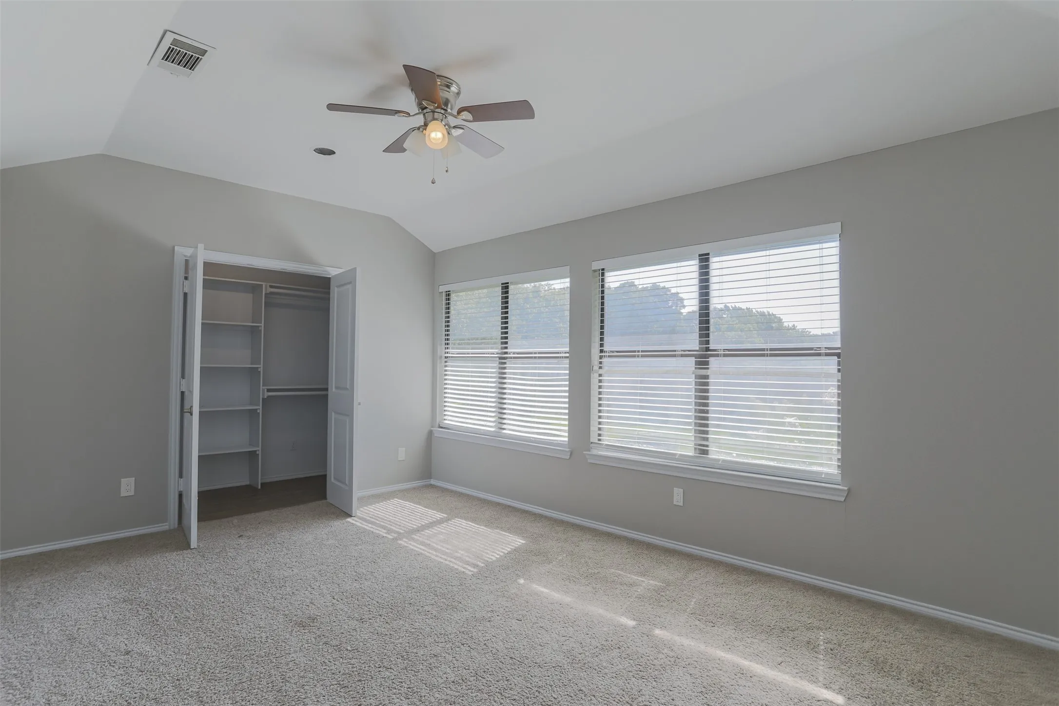 Bedroom with lots of natural lighting and walk-in closet.