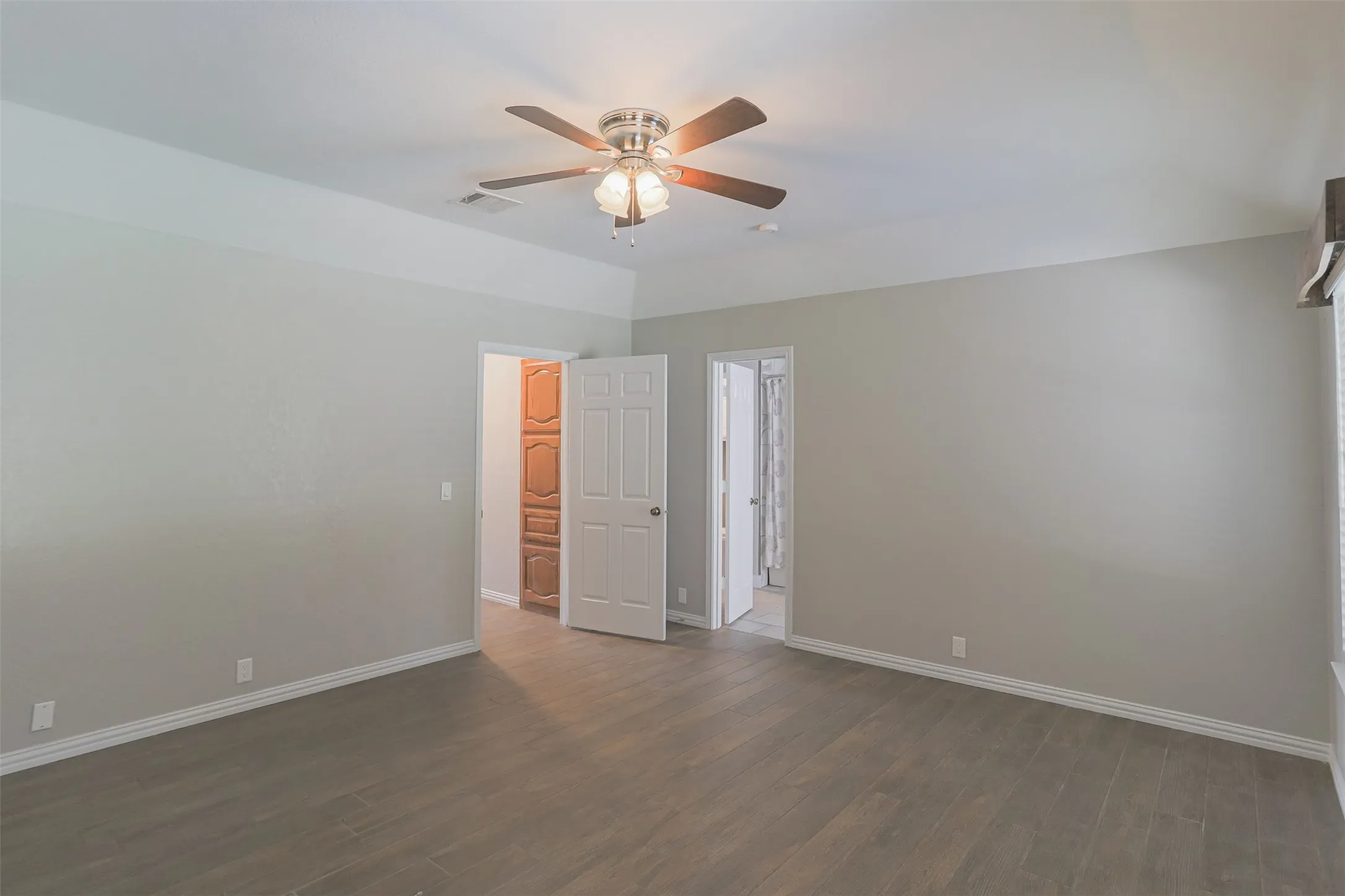 Bright and airy primary bedroom with a spacious, functional layout.