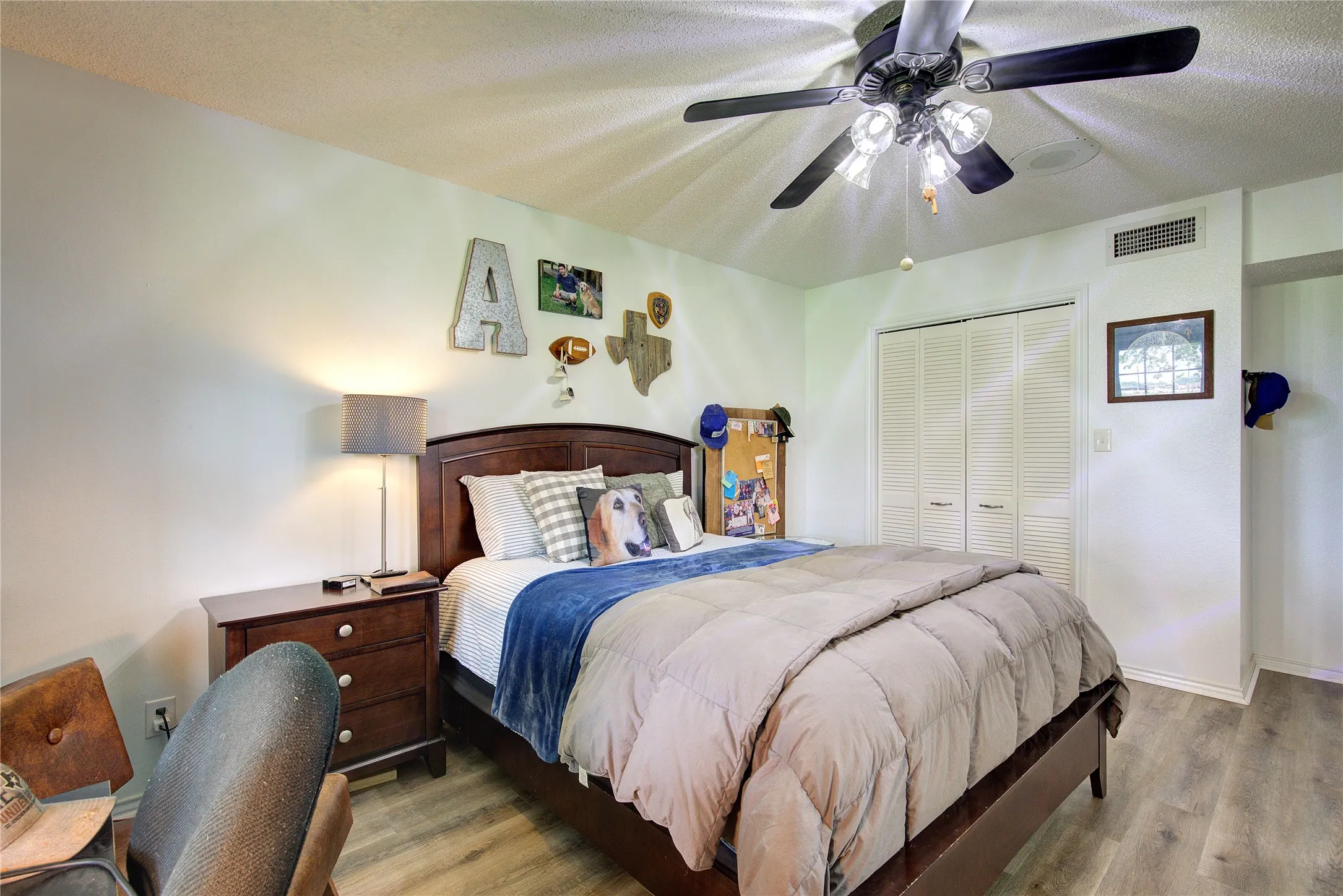 Downstairs primary suite has closet, room for seating or desk.