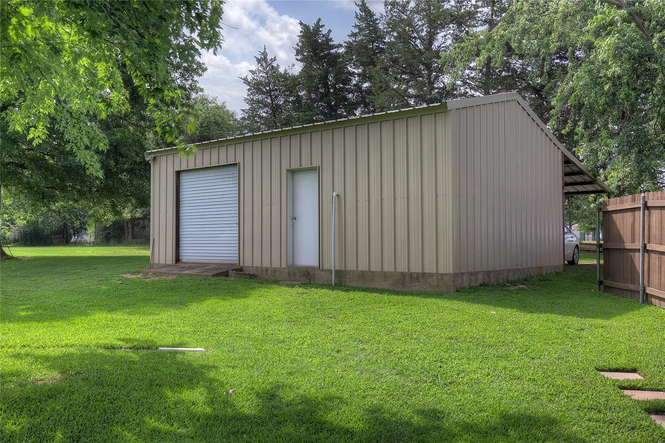 Steps away from the house is a 30x20 shop with electric and one roll-up door, with overhang behind.