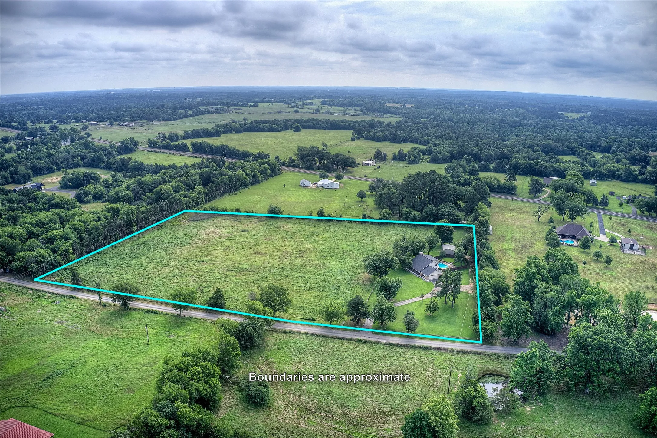 8.953 gorgeous acres, fenced, with a 4 bedroom house, 30x20 shop, and pool.