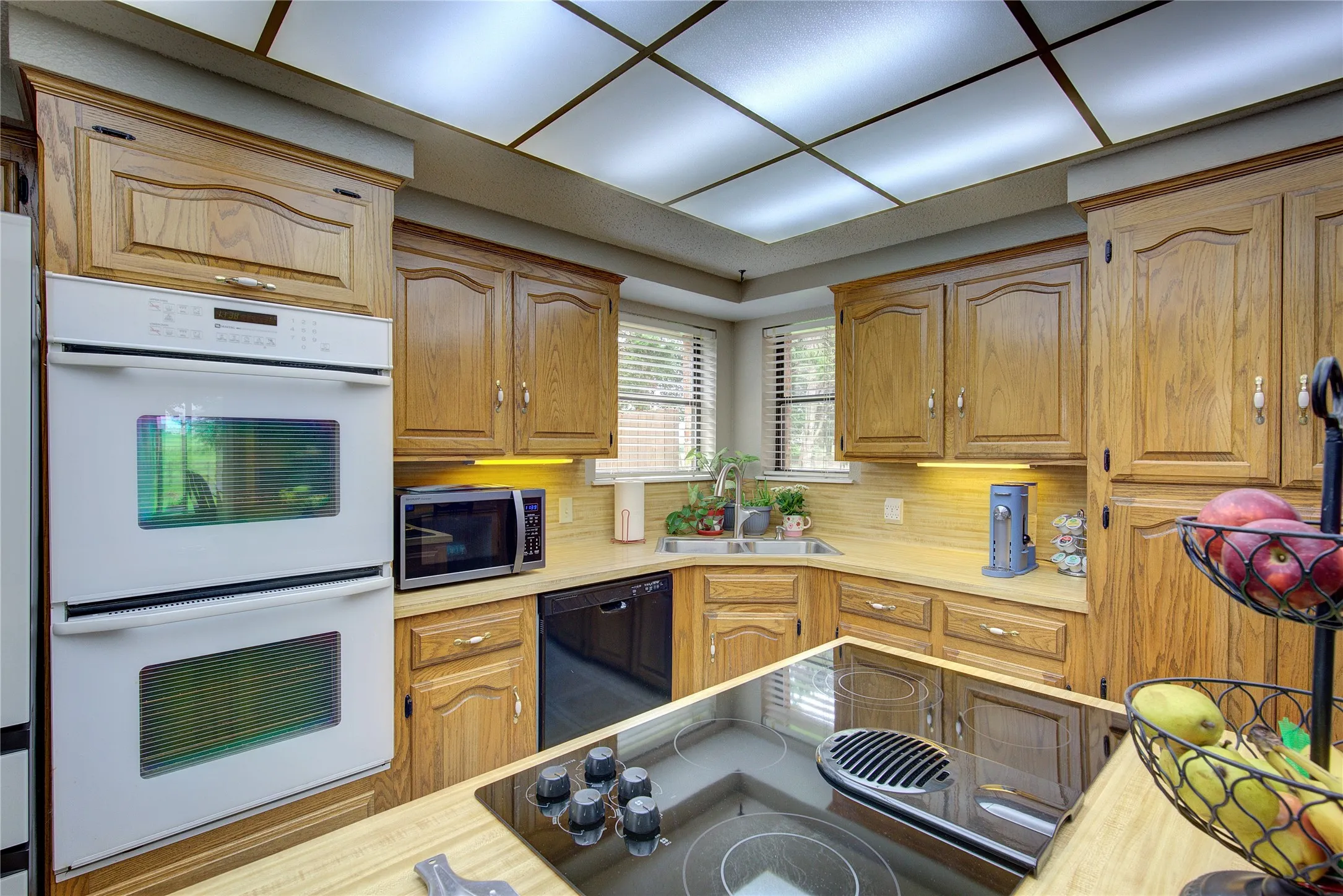 Kitchen has corner sink with two windows, all electric appliances, lots of storage!