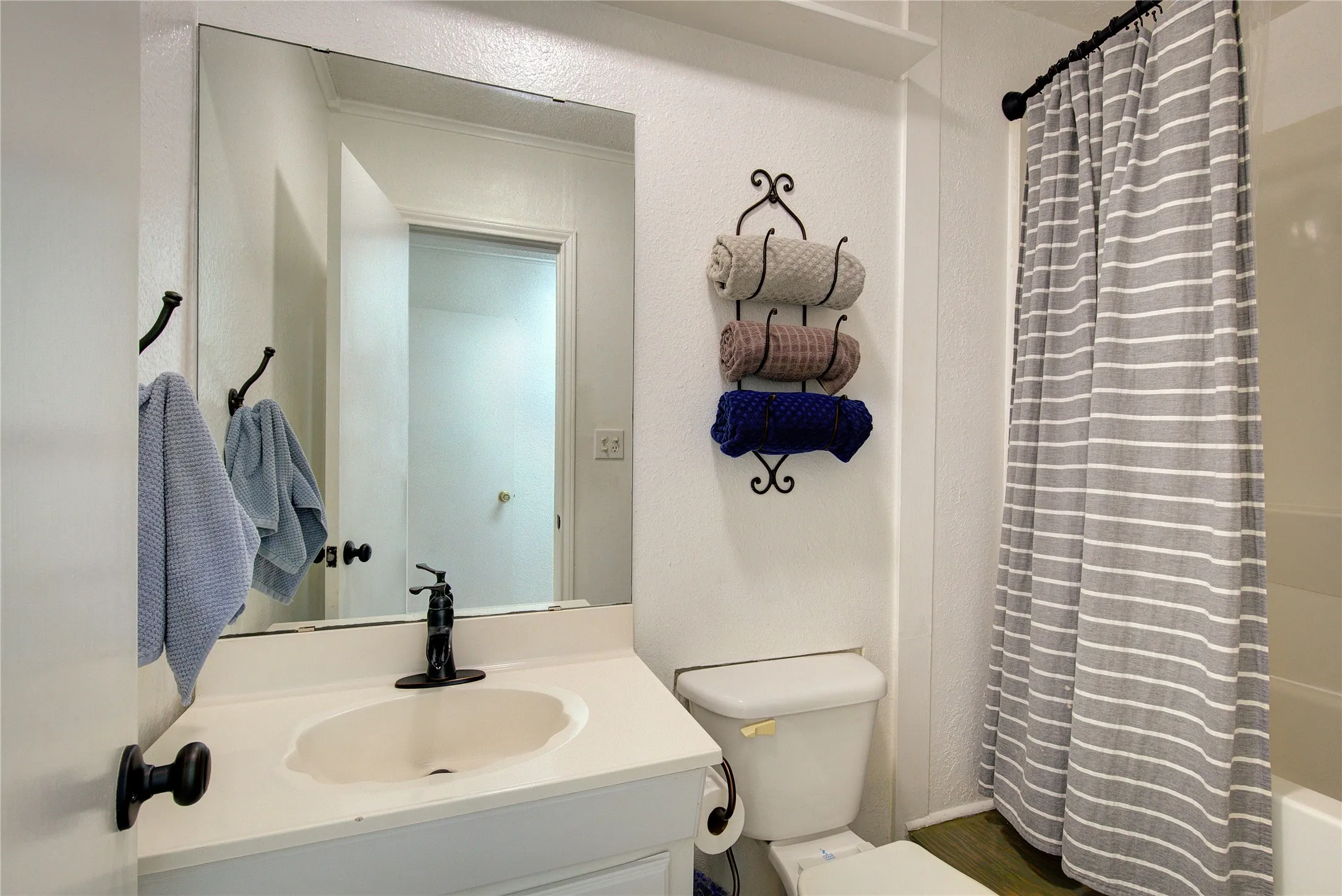 Full bathroom next to utility room, across from garage entrance, makes a perfect mud room / washing-up room.