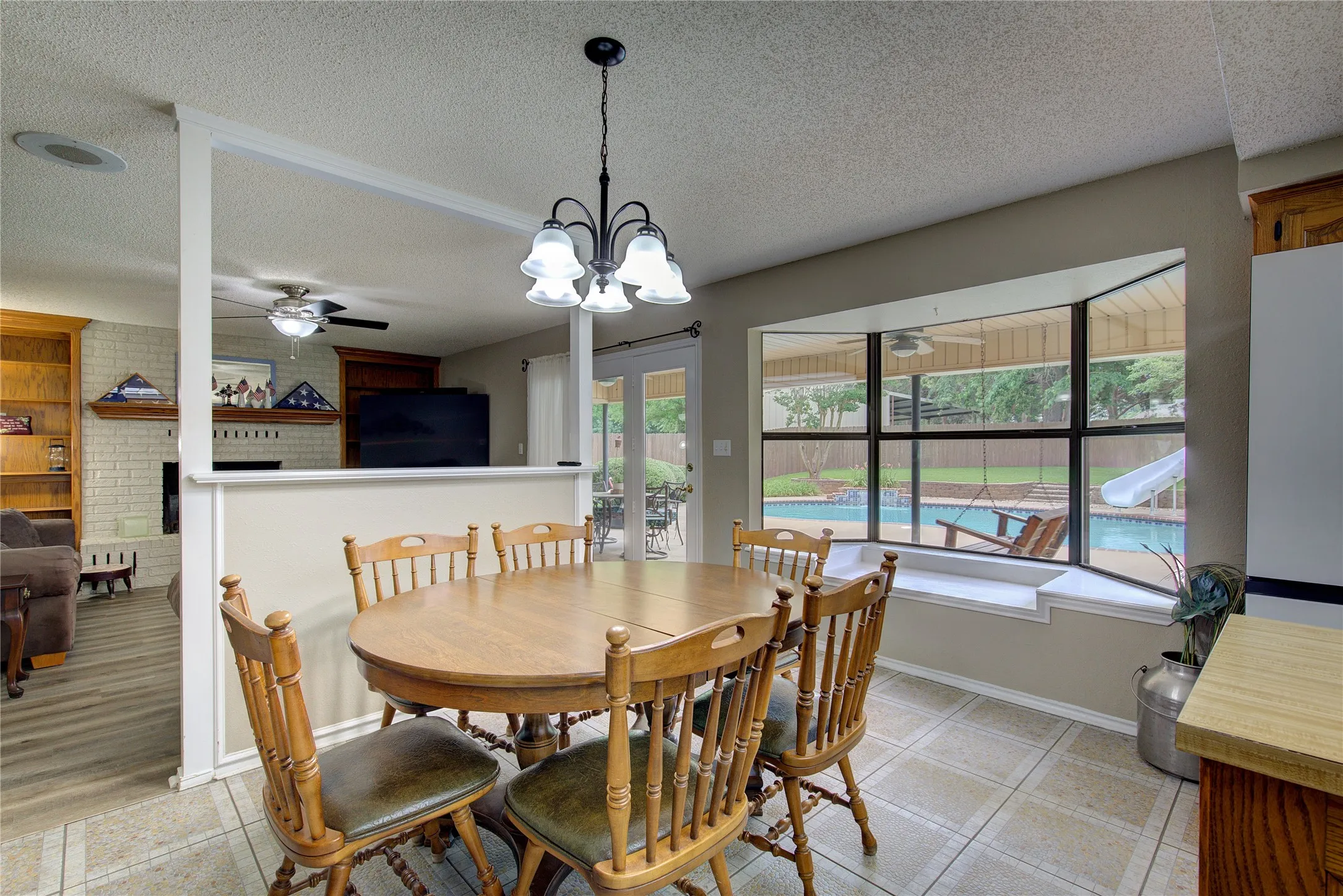 Breakfast area has amazing bay window with built-in seating bench overlooking the pool!