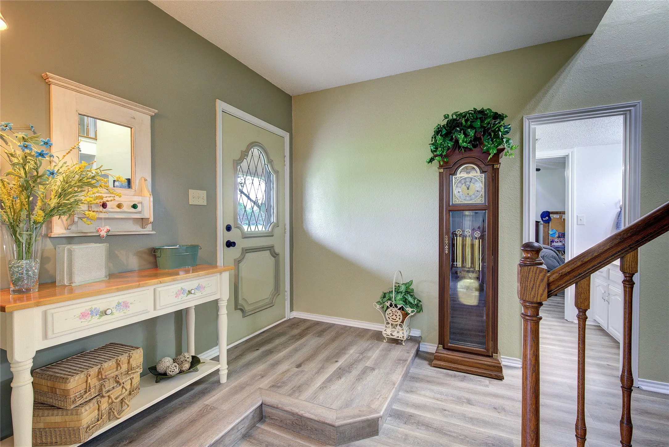 Walk into a grand entryway with a curved wooden staircase to the second floor. new LVP in most of home