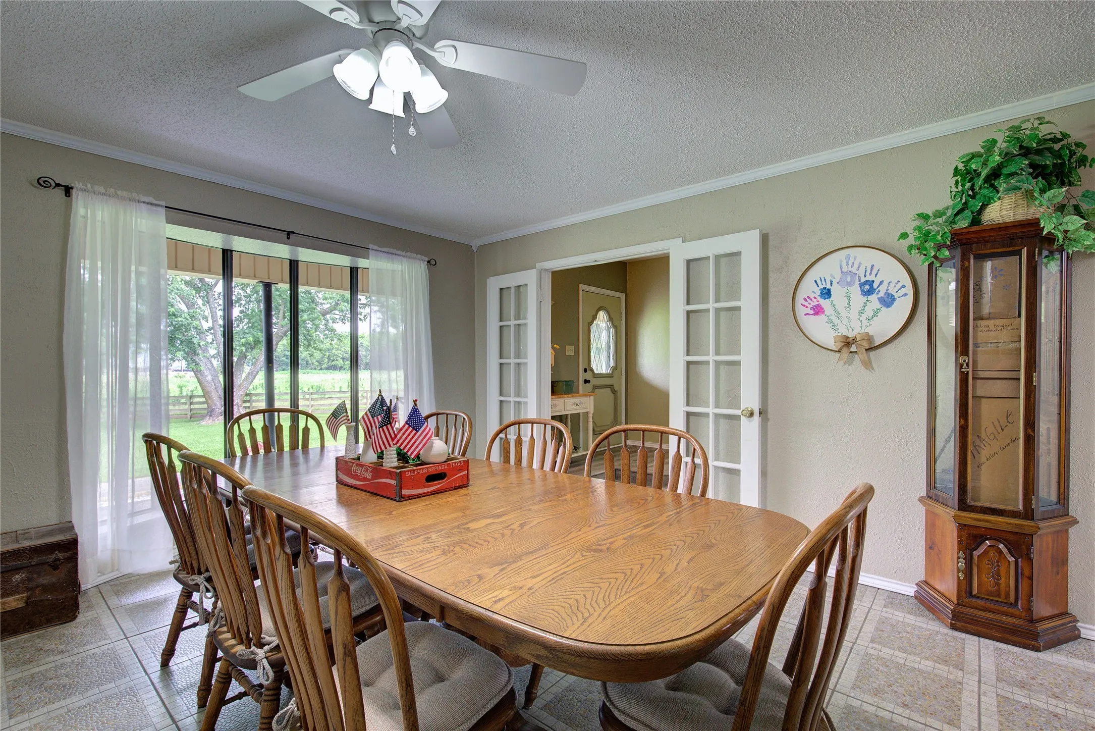 Large formal dining has french doors from entryway, bay window.