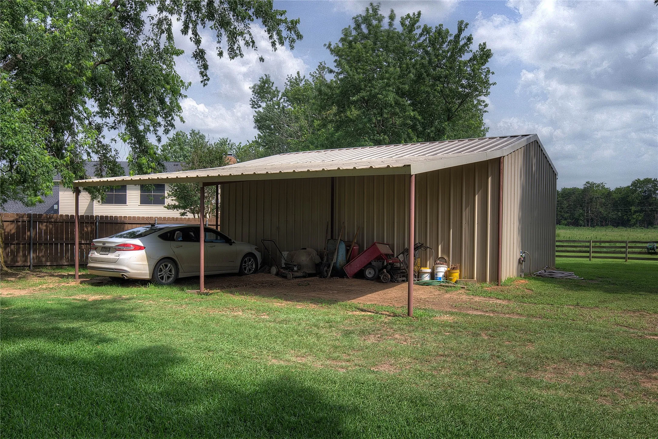 behind the workshop is on overhang for equipment or extra vehicles.