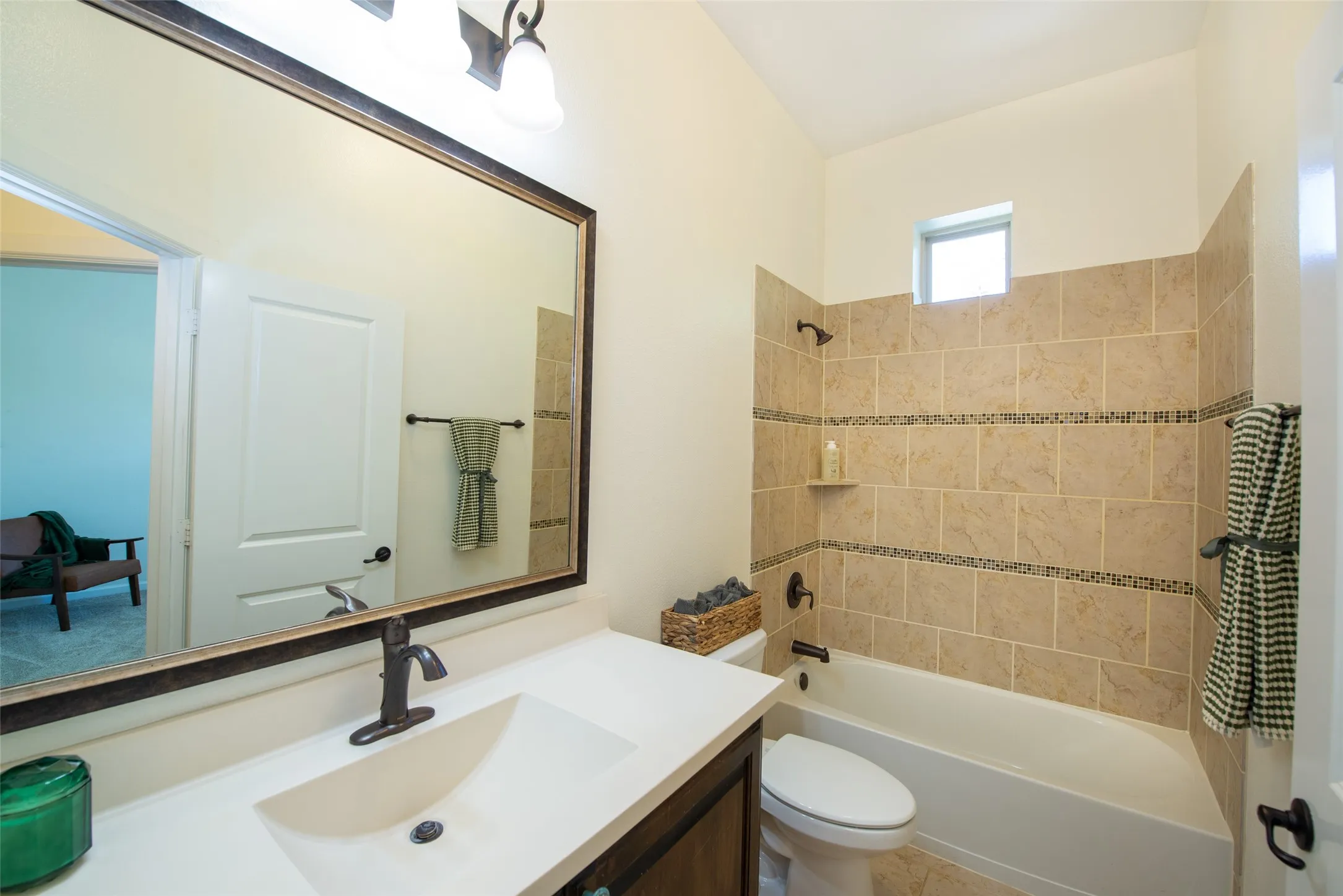 Full bathroom featuring a single vanity with a white countertop, an integrated rectangular sink, and an oil-rubbed bronze faucet