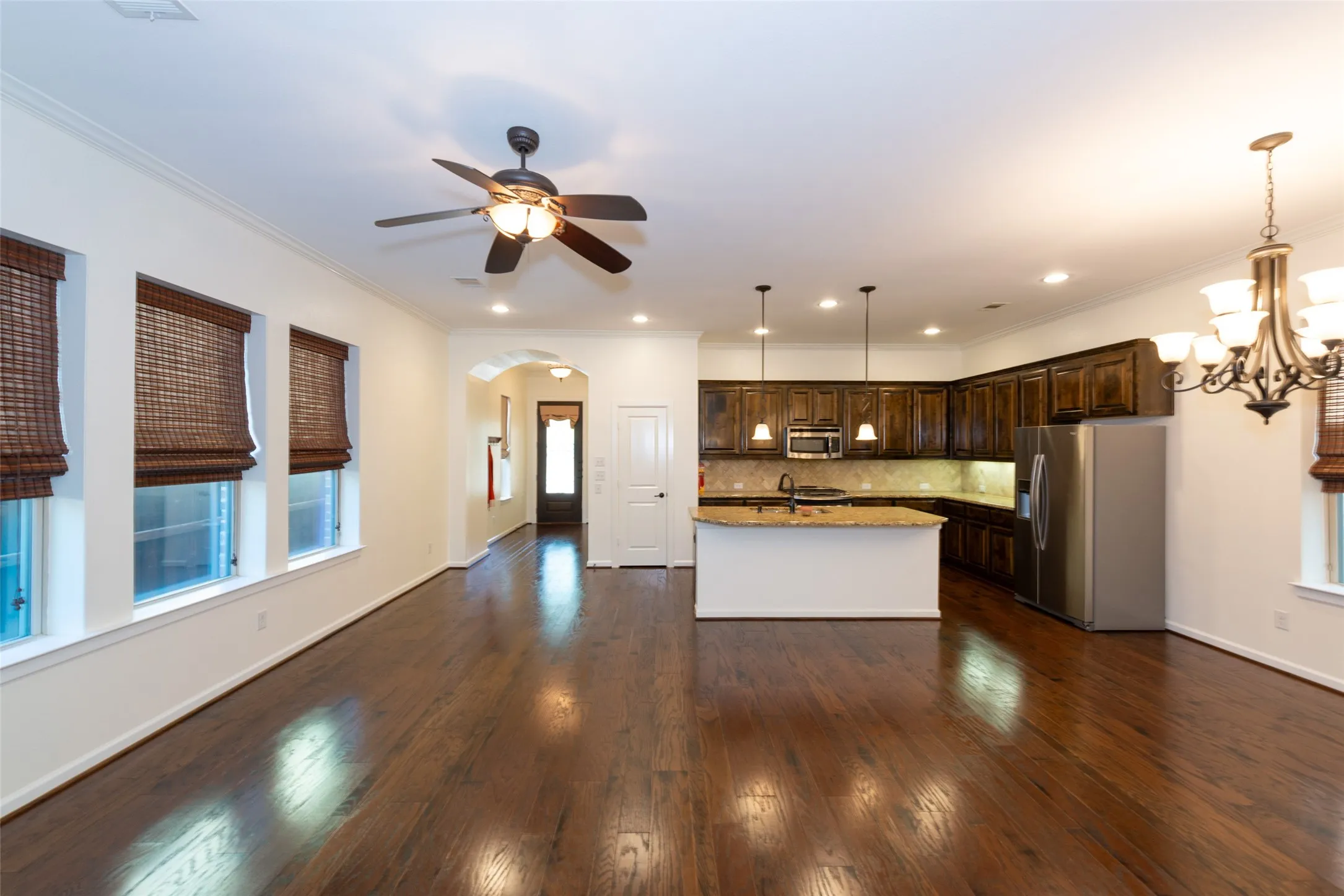 Open-concept space featuring dark wood-finish flooring throughout