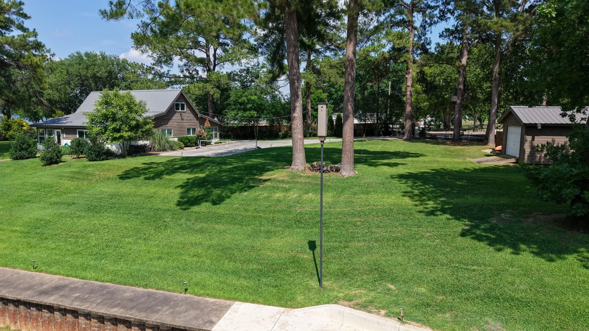 Situated on 2 lots with towering pine trees with room to expand home, add garage, add a pool and more.