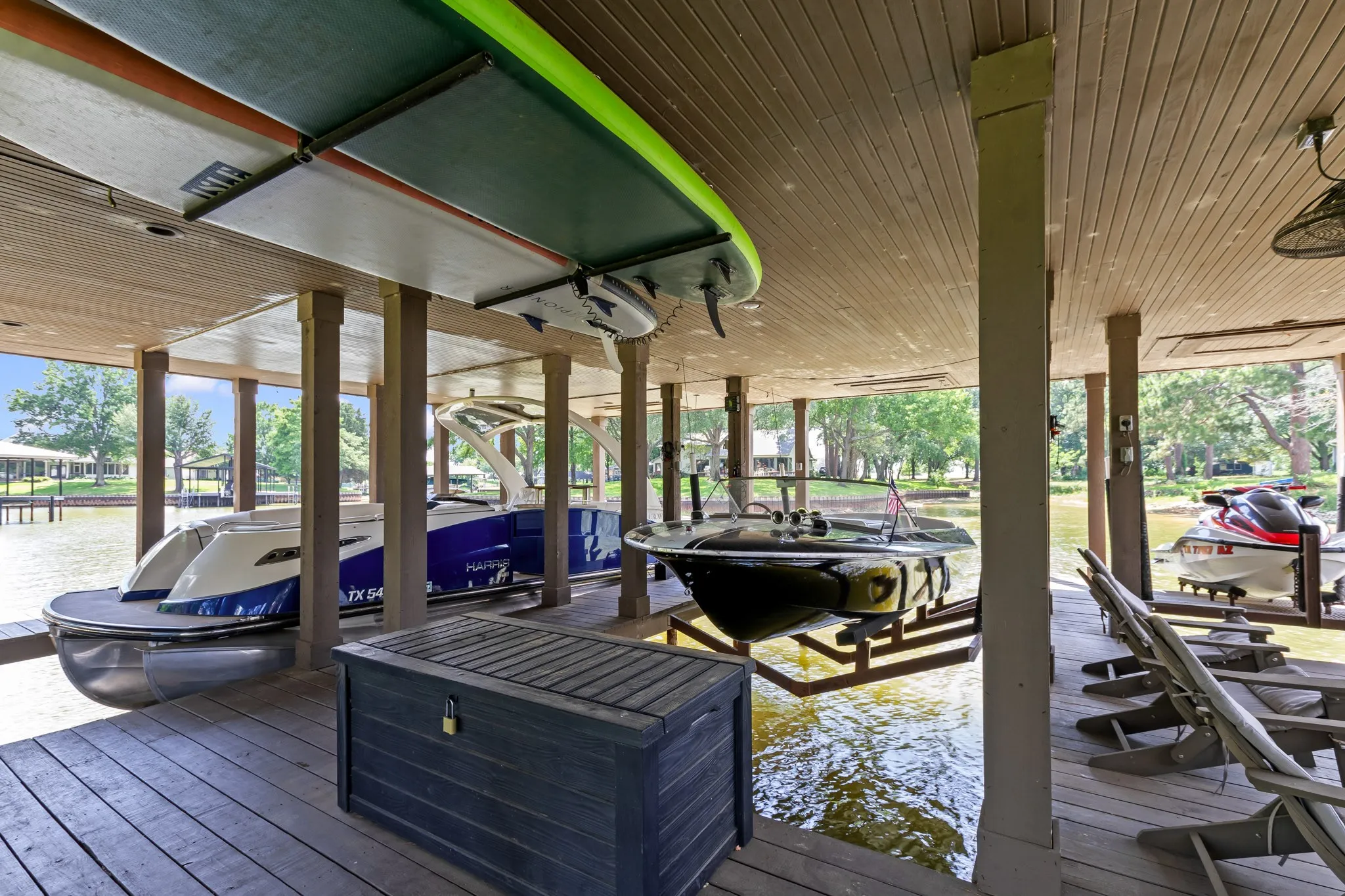 Double-Slip Boathouse with Personal watercraft lift and covered sitting area.