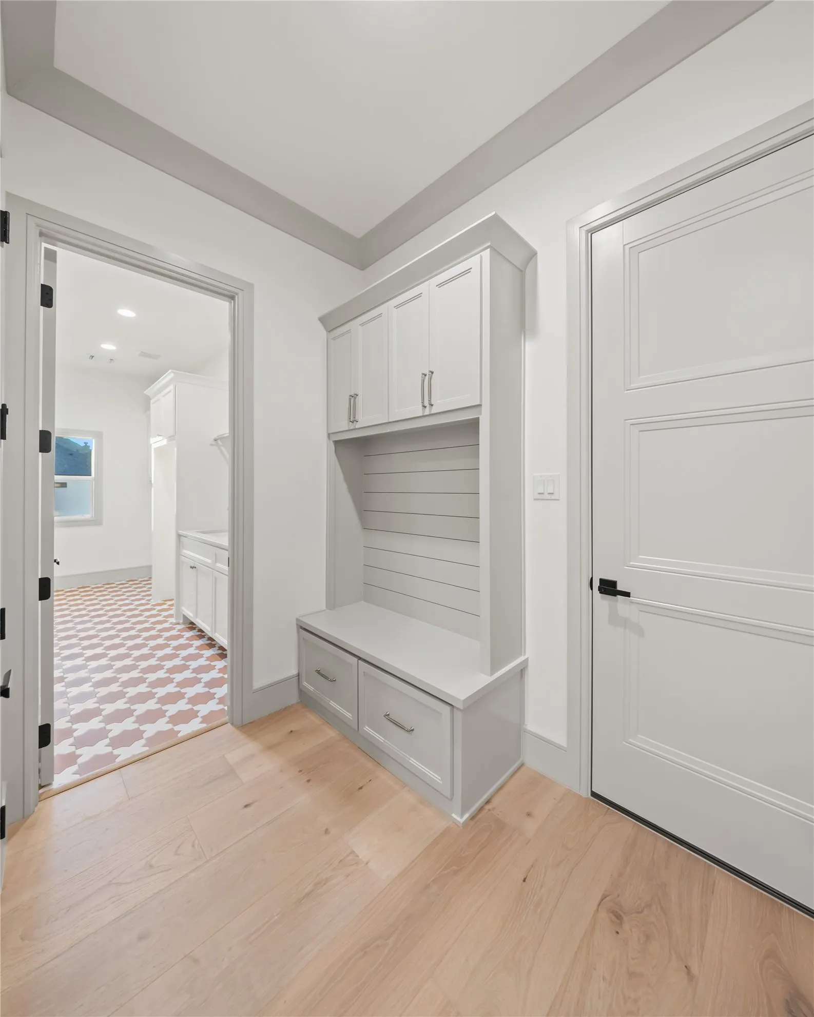 Built-in mudroom bench with shiplap backing and shaker-style cabinetry