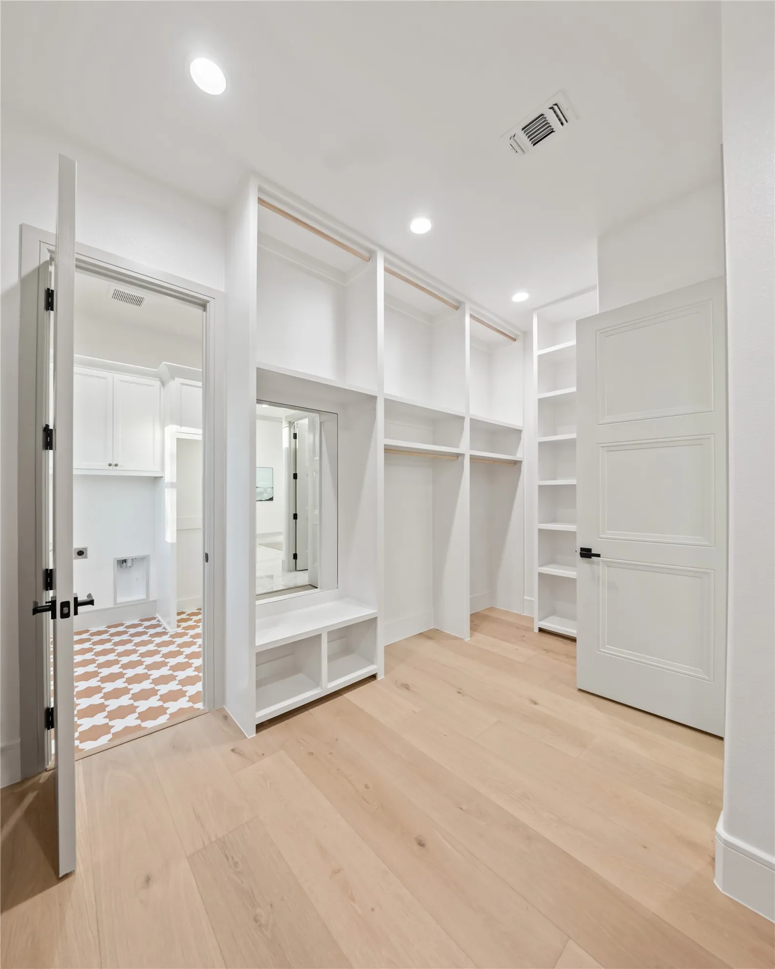 Custom closet system with extensive shelving and hanging rods