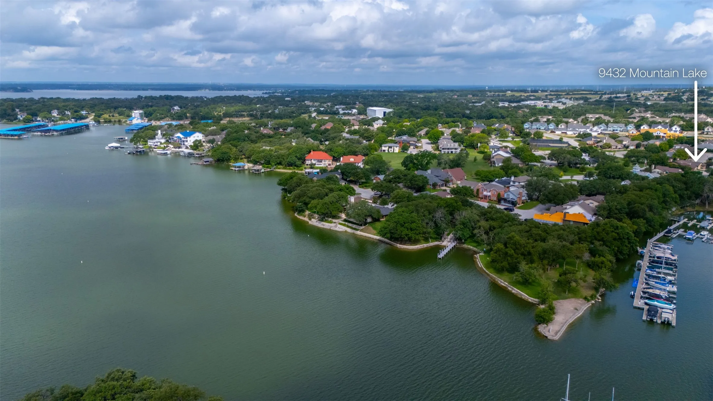 Aerial view of lake, marina, and park.