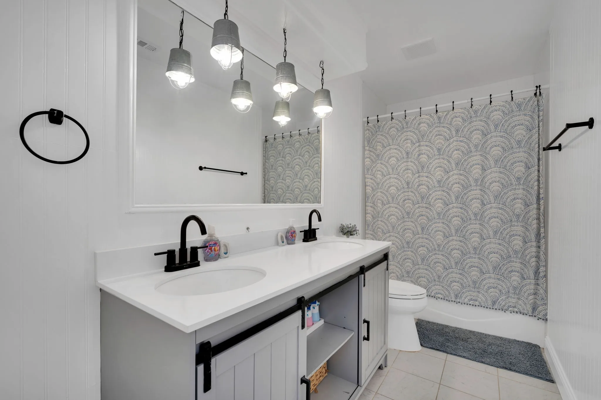 Dual-sink vanity with matte black fixtures and a white countertop