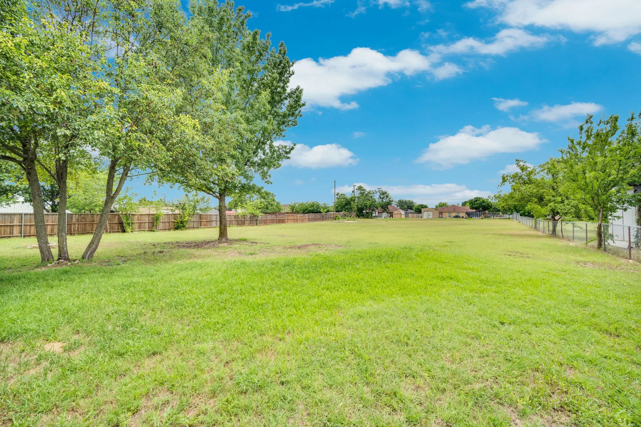 Expansive green lawn with established trees