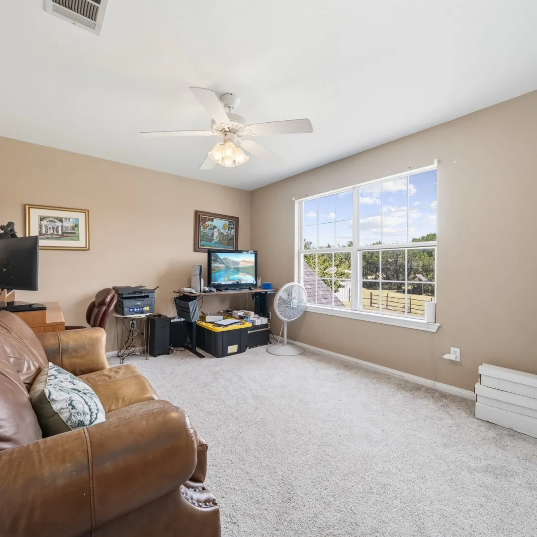 Spacious room featuring neutral carpeting and wall tones
